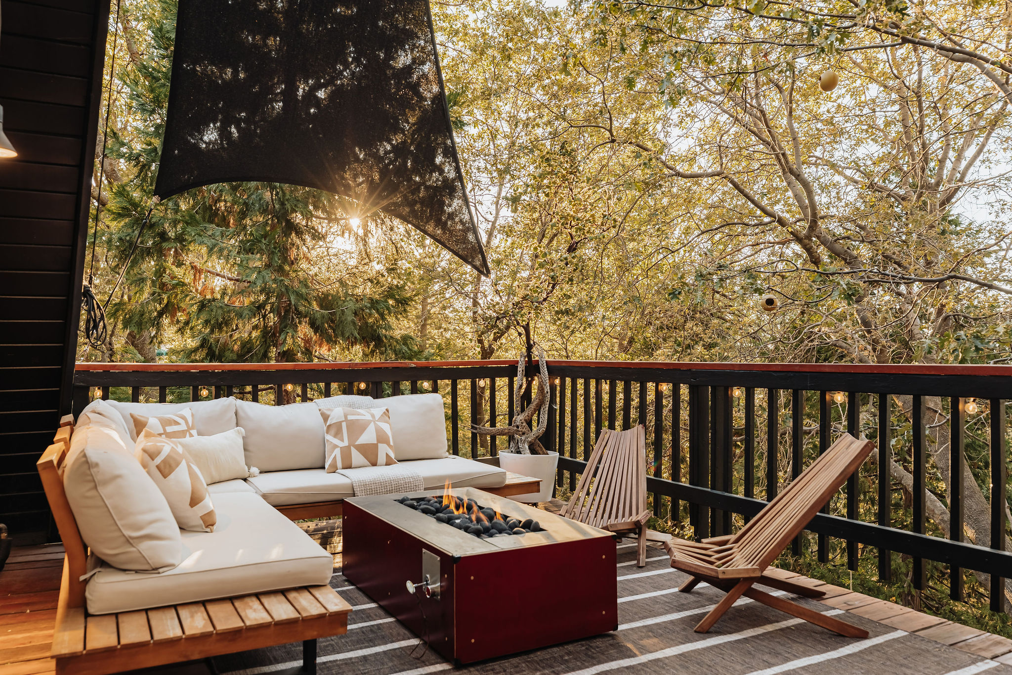 Private treetop deck with cozy fire table and serene lounge seating