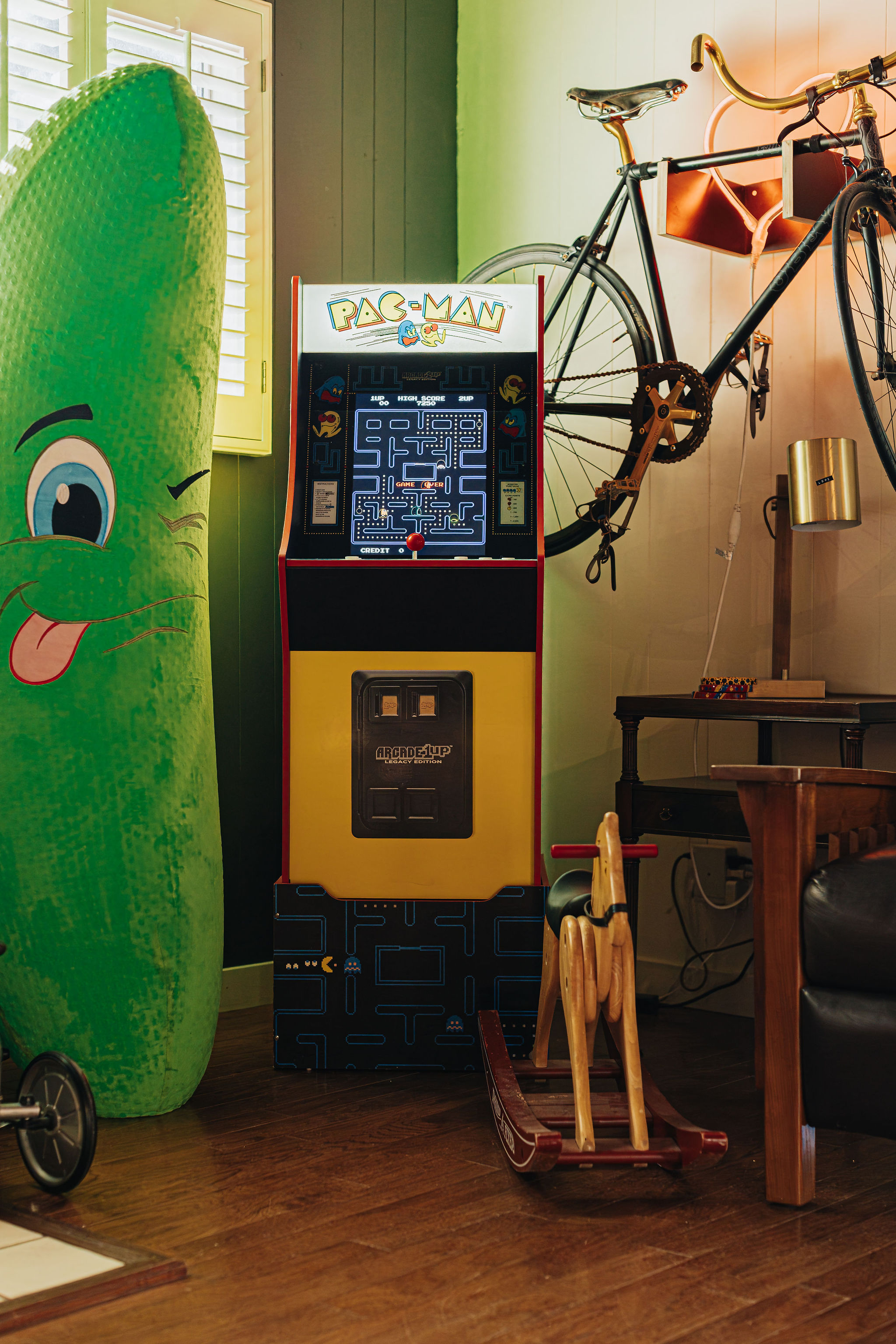 Retro Pac-Man arcade corner with quirky decor and vintage character