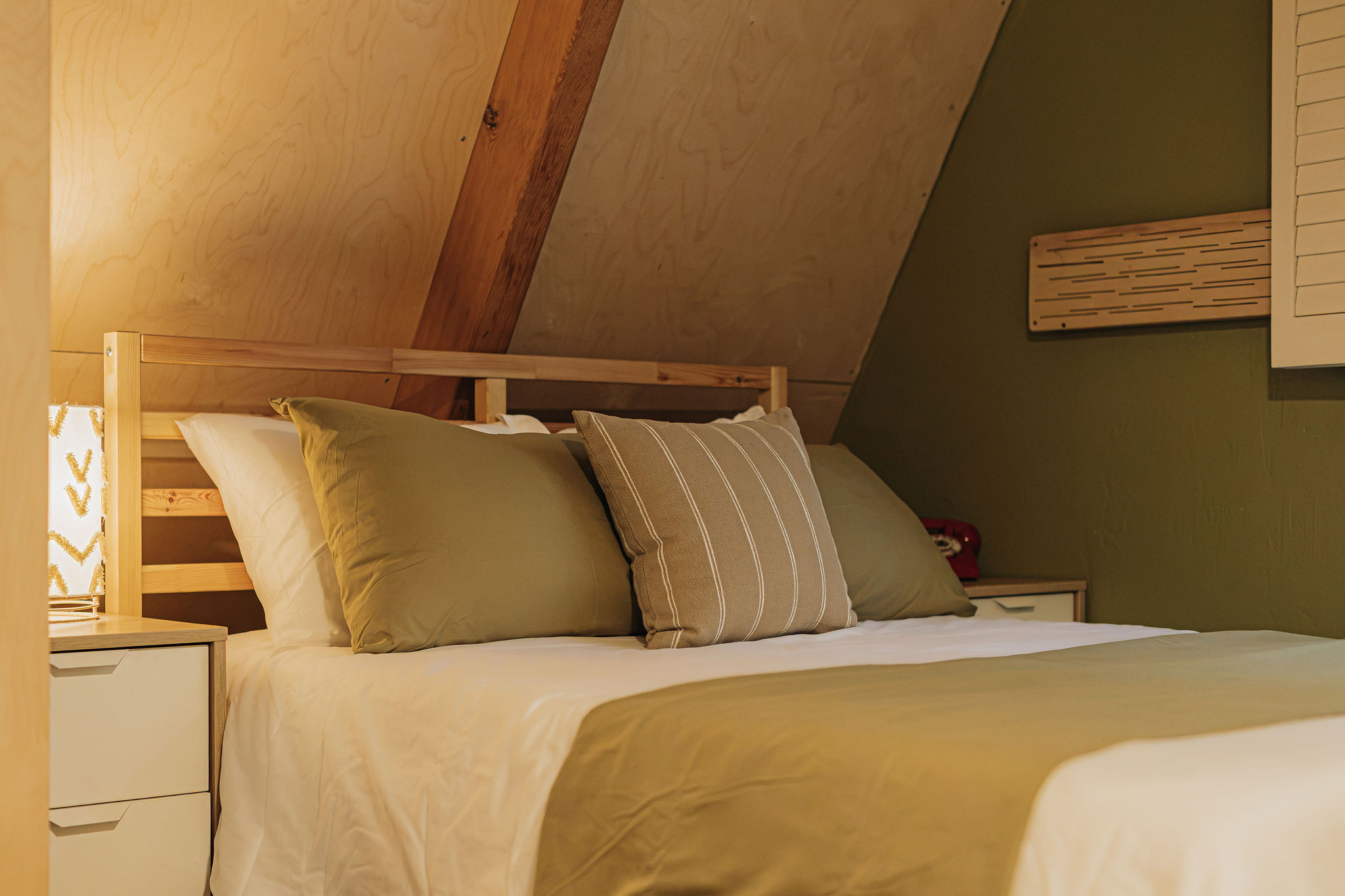 Cozy loft-style bedroom with warm wood accents and plush bedding