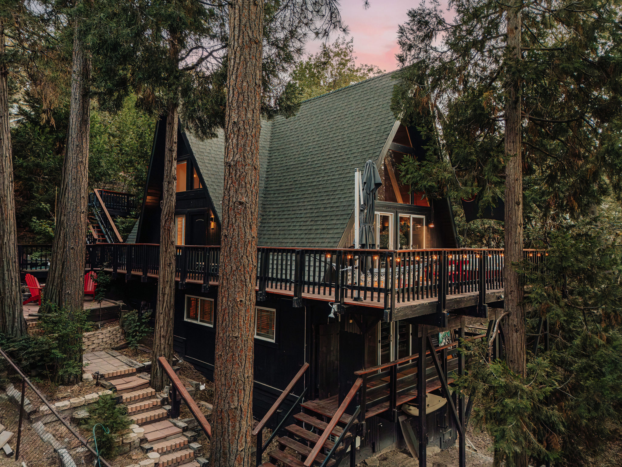 Cozy forest A-frame with a spacious deck and peaceful woodland setting