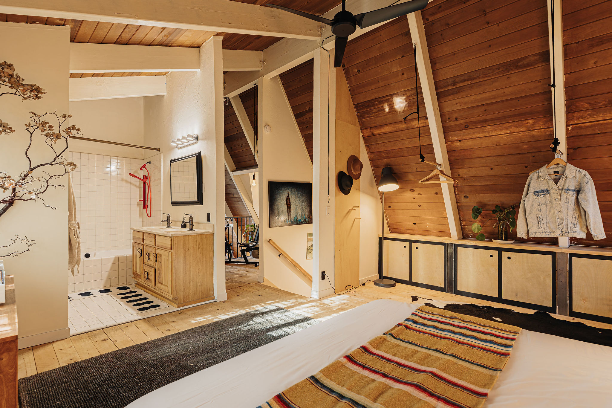 Cozy A-frame loft bedroom with ensuite bath and warm wood details