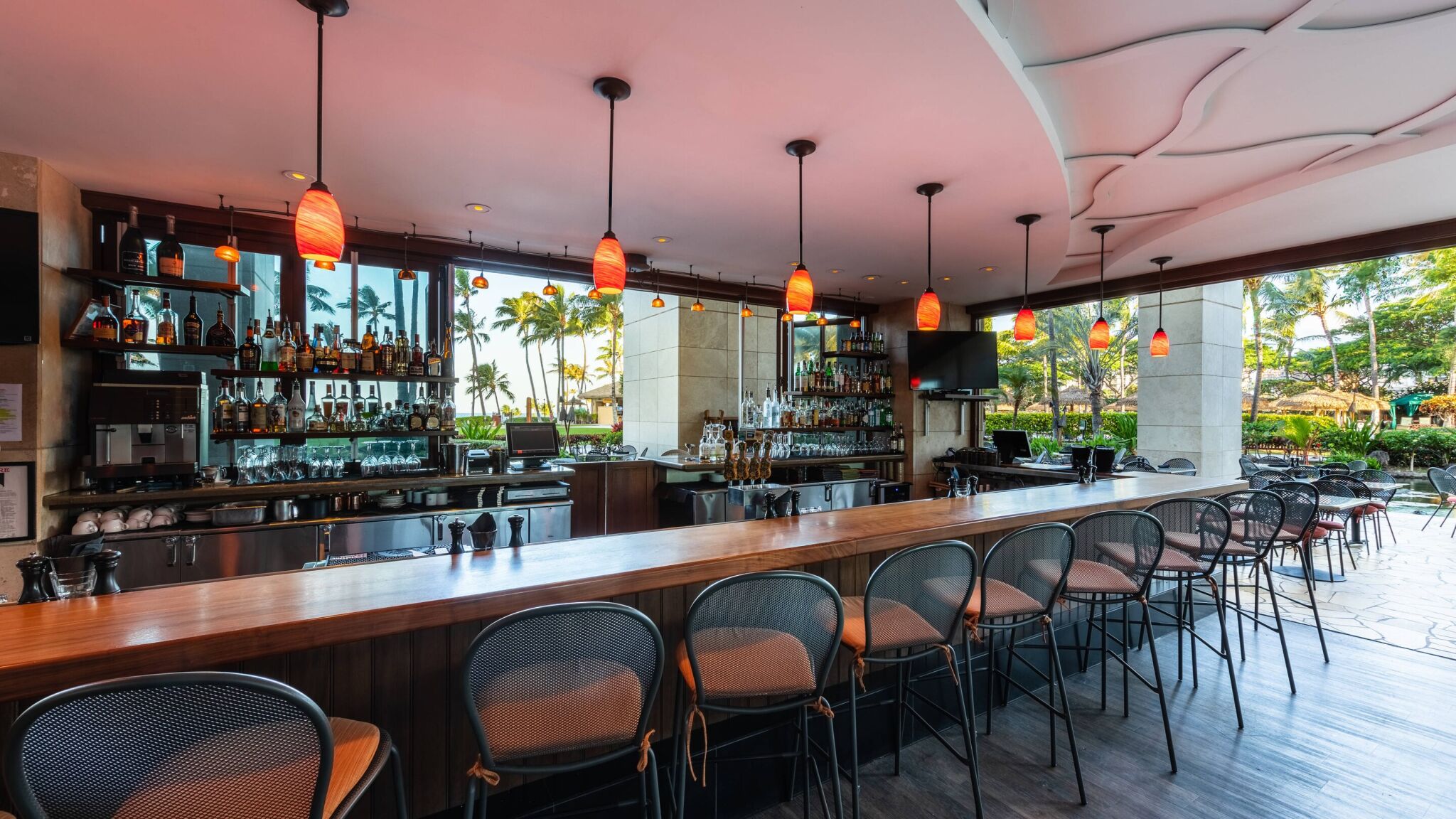 Open-air resort bar with tropical views, chic seating, and inviting ambiance