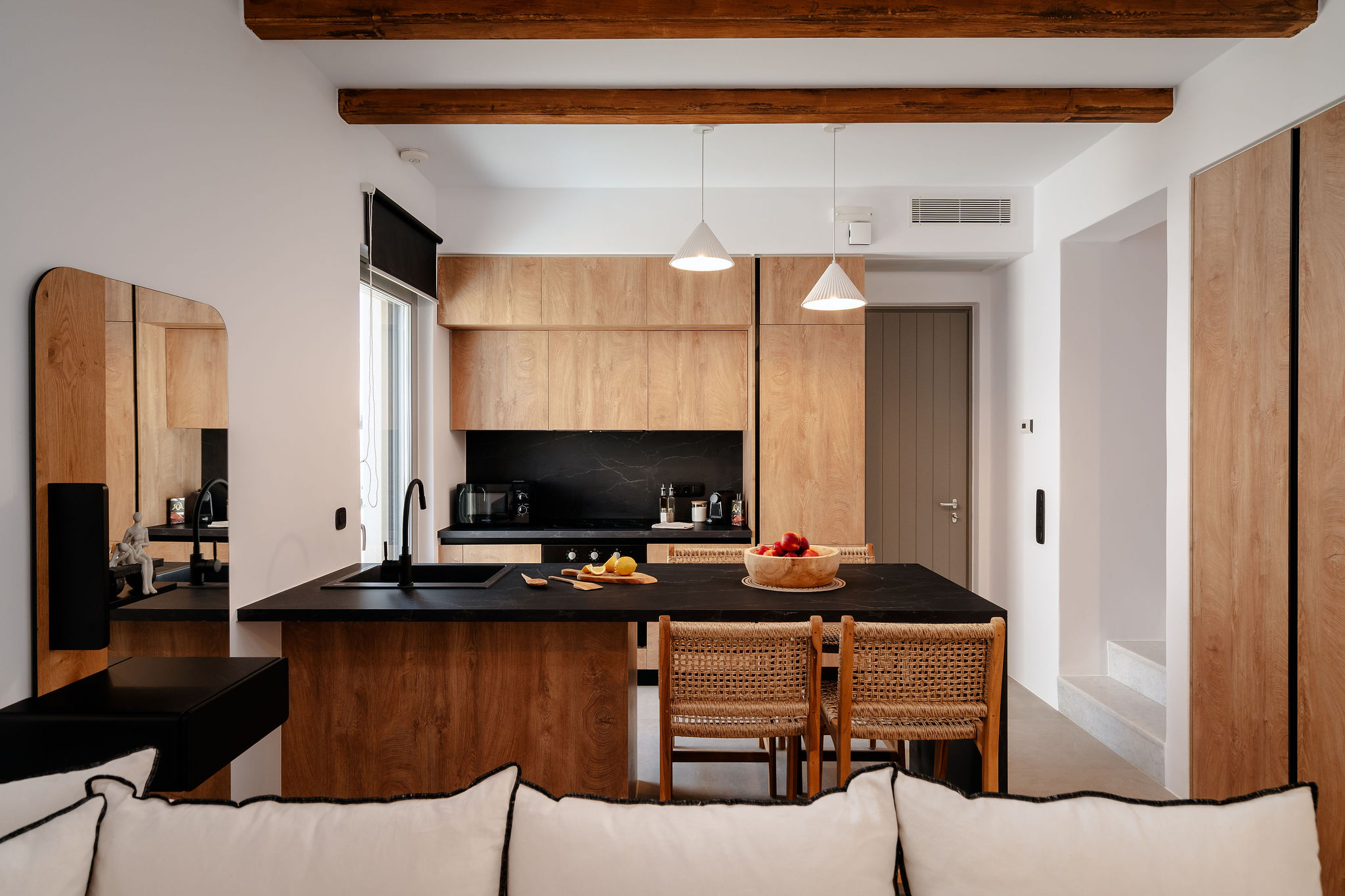 Modern wood-accented kitchen with island seating and designer touches