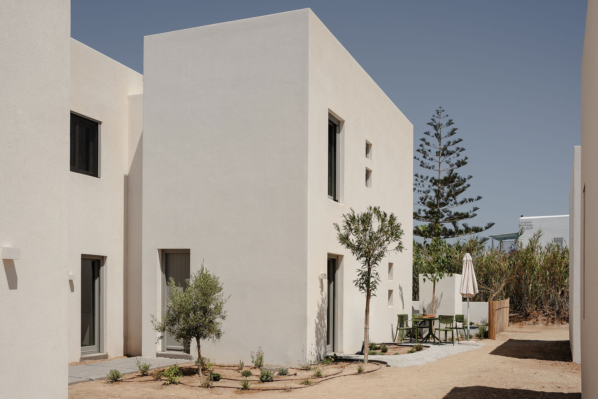 Modern whitewashed courtyard with private patio seating