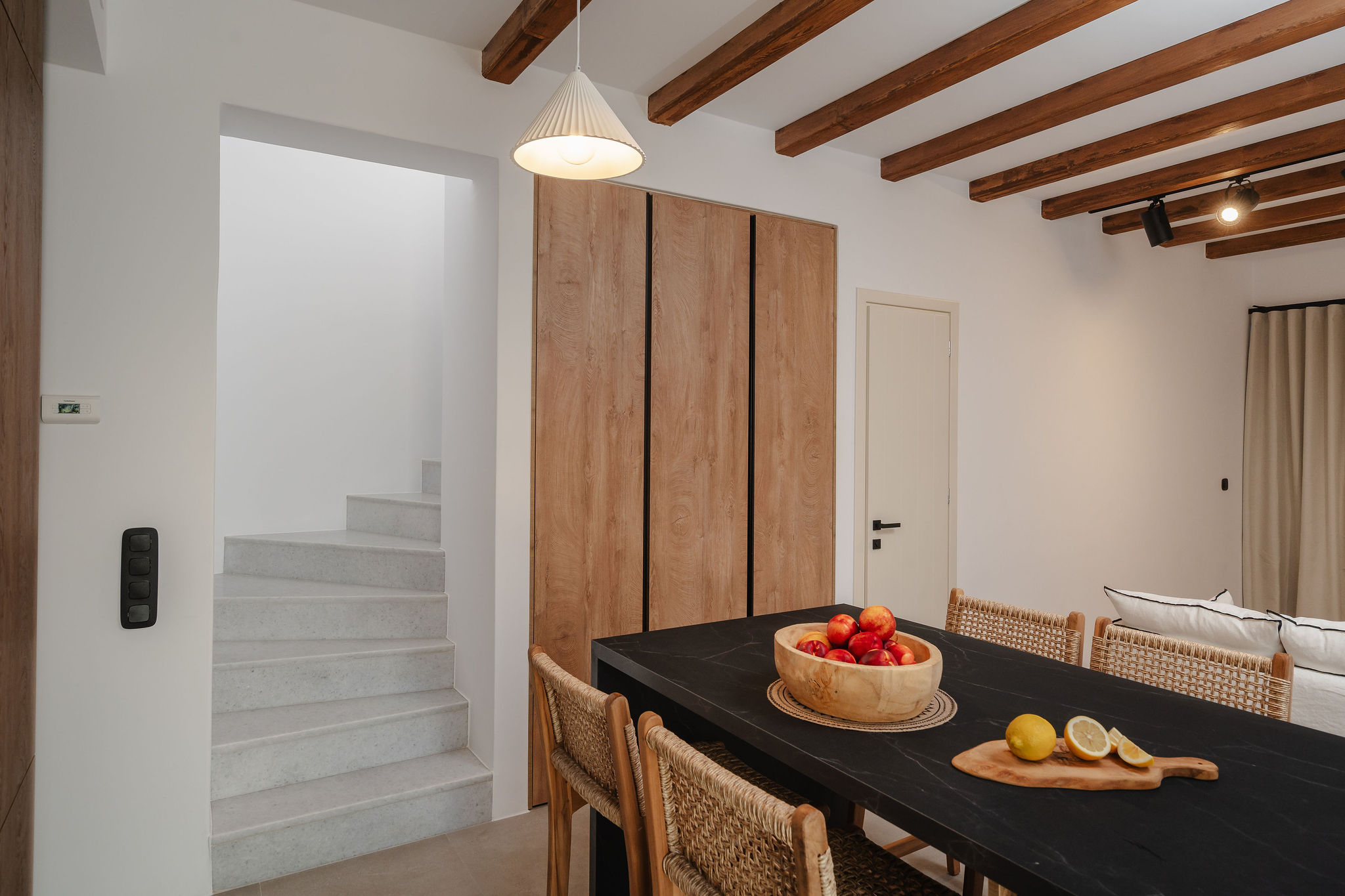 Bright dining space with exposed beams and warm natural wood accents