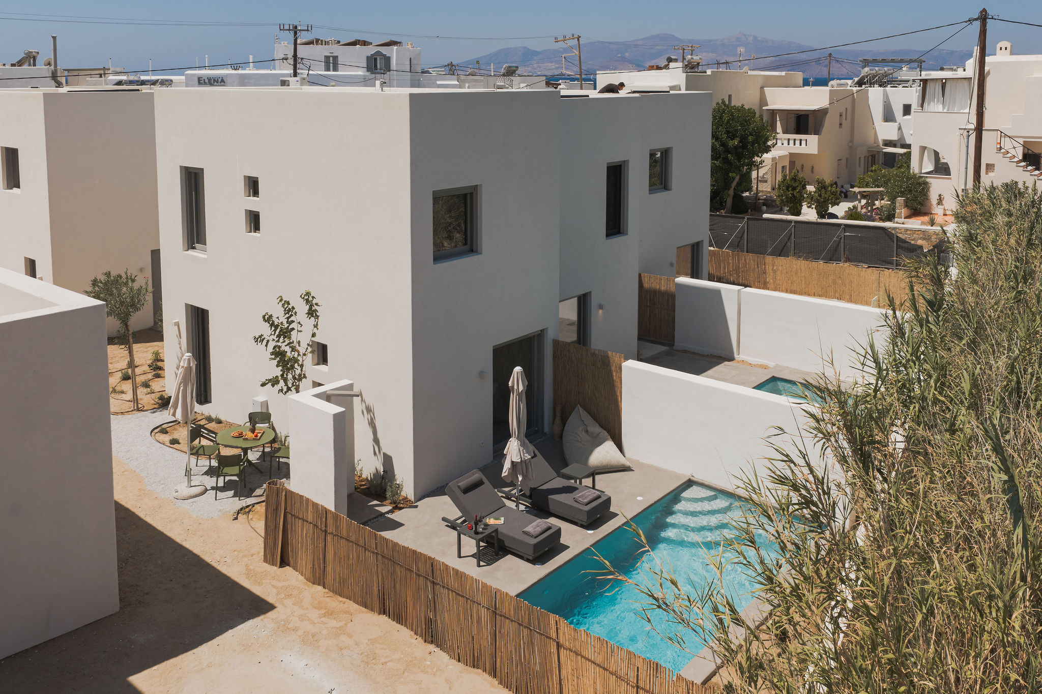 Modern villa with private pool, sun loungers, and stylish outdoor living