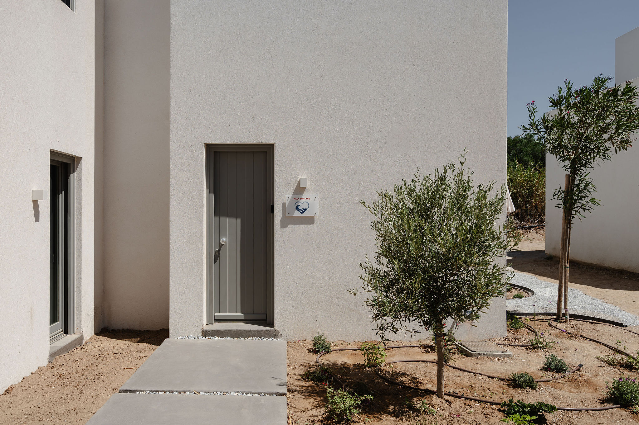 Private entrance to a sleek modern villa with desert landscaping