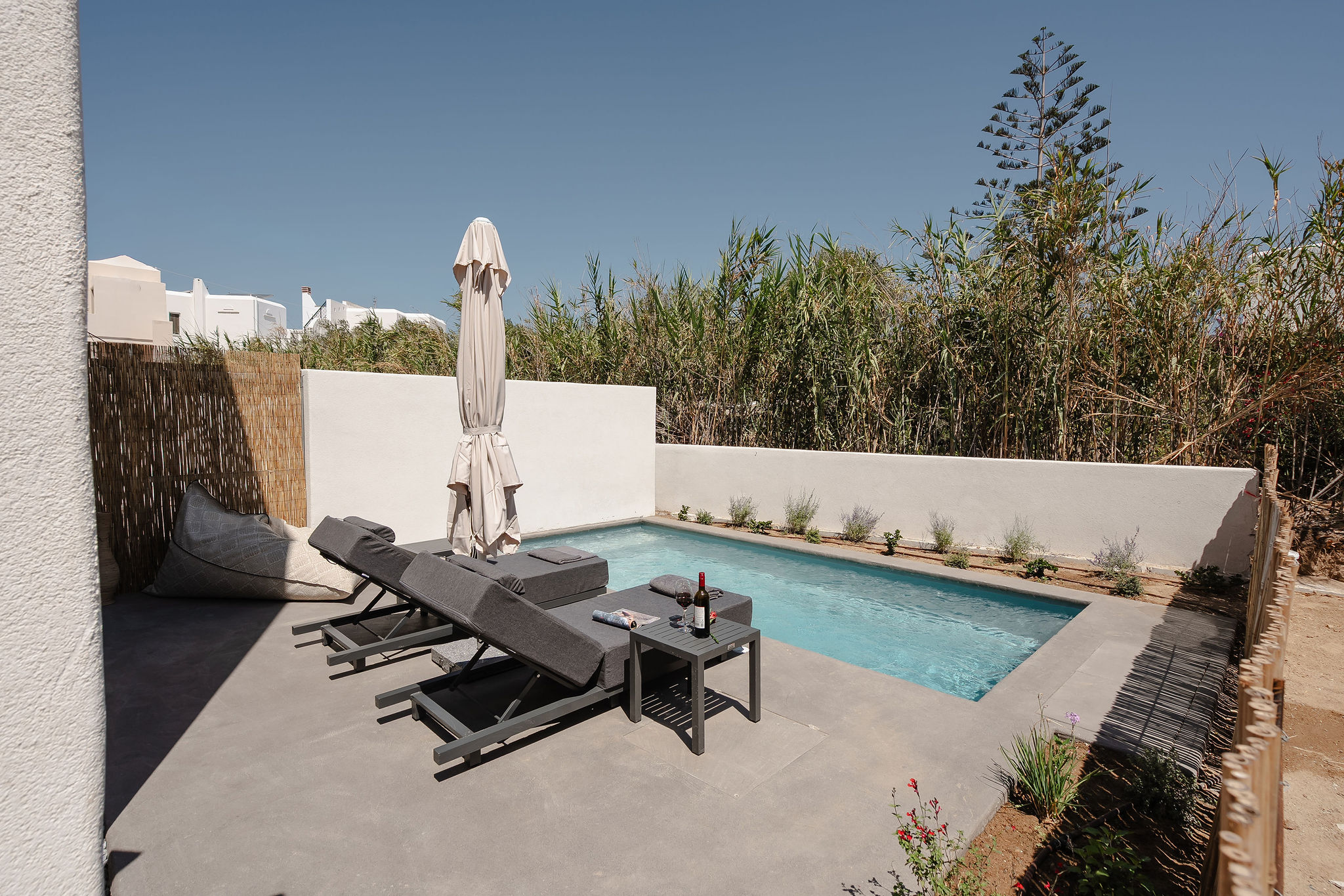 Private plunge pool with loungers and a serene sun-soaked patio