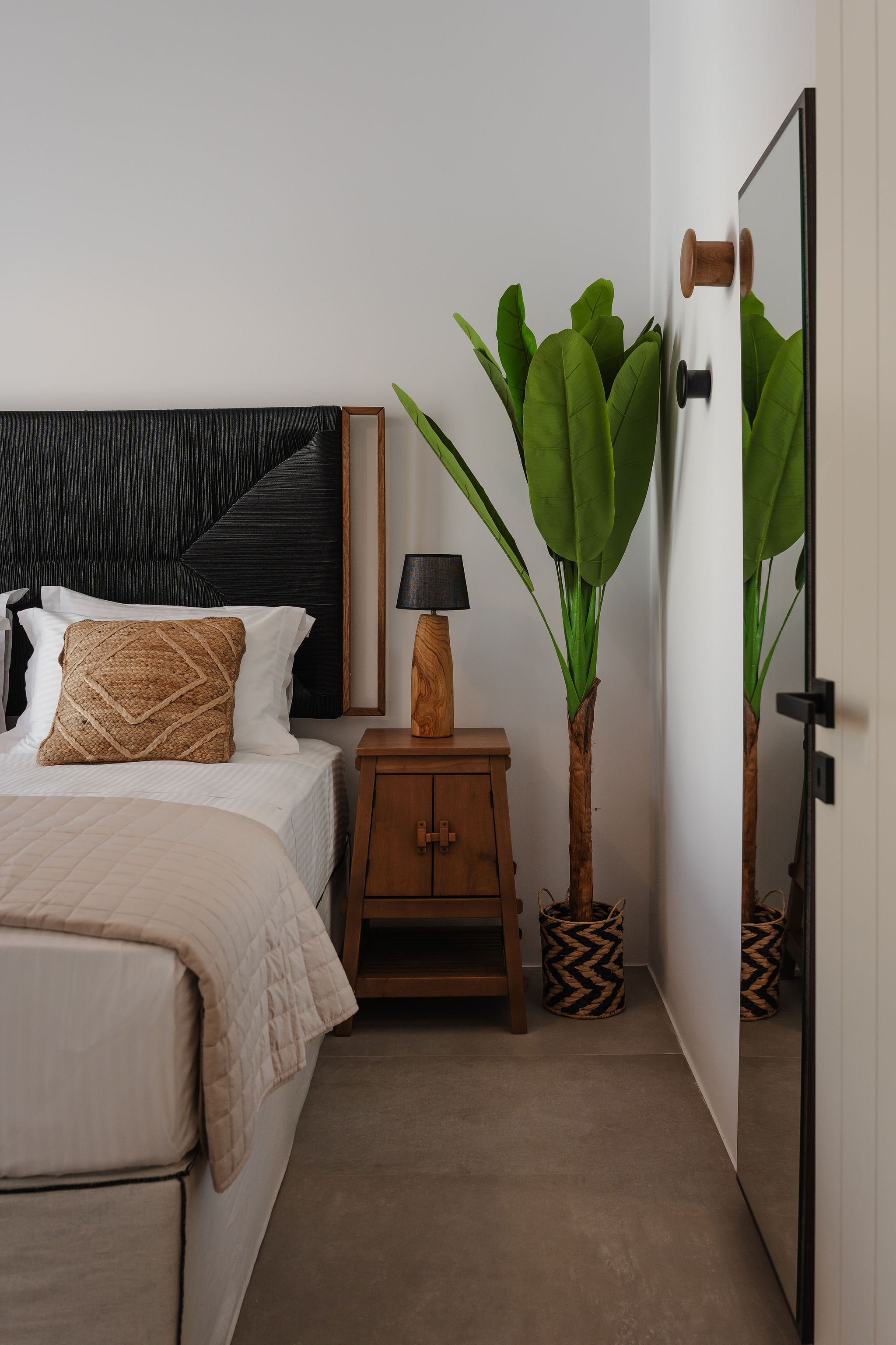 Modern bedroom retreat with warm wood accents and a full-length mirror