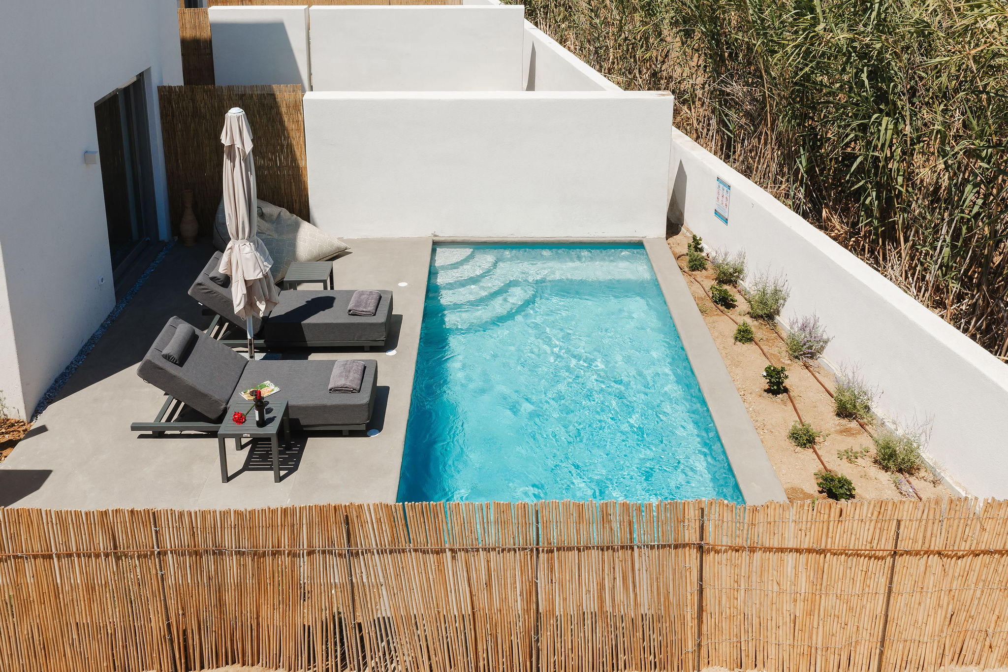 Private plunge pool with sun loungers and a sleek, secluded deck