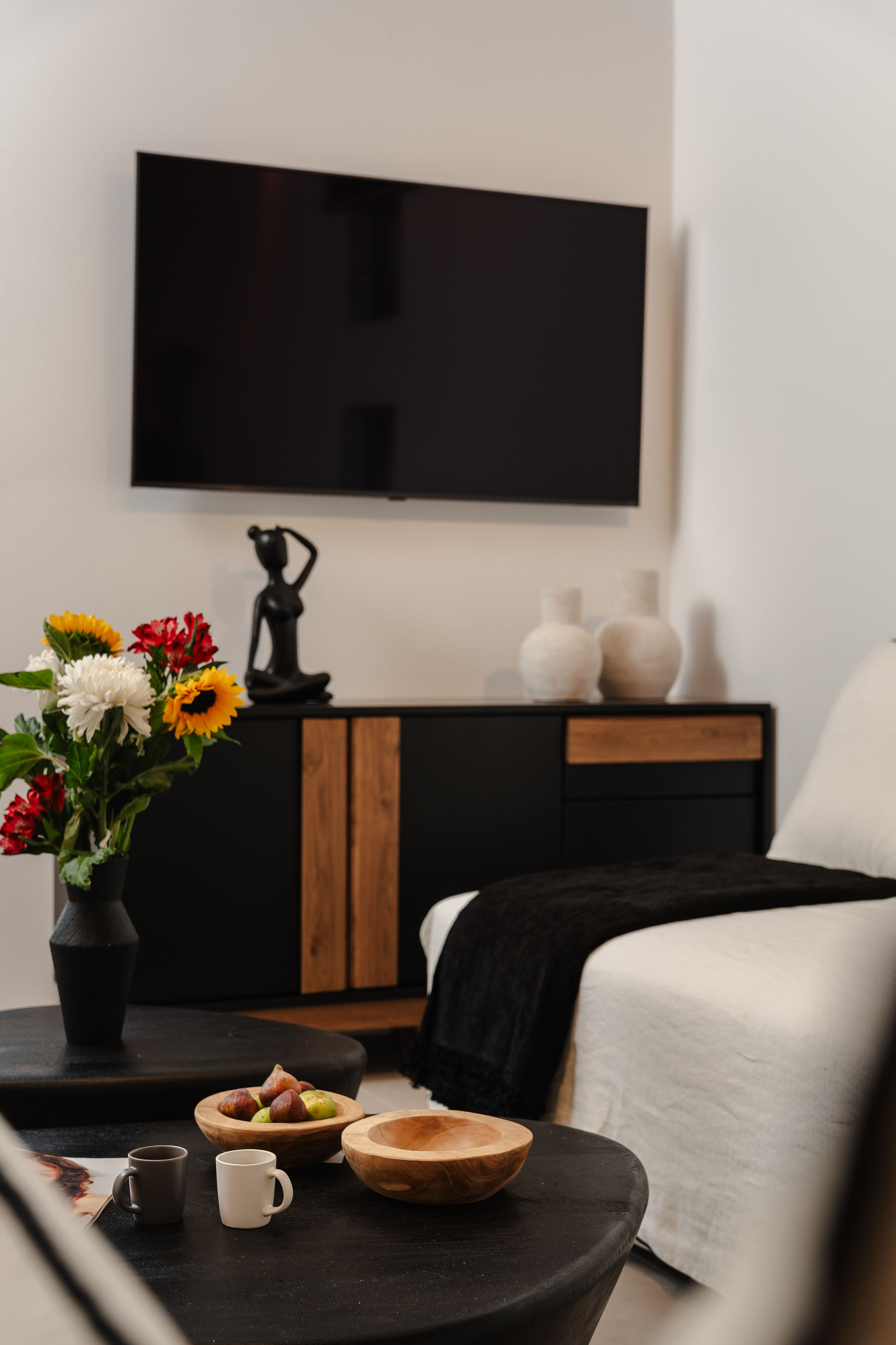 Modern lounge with smart TV, stylish decor, and cozy seating