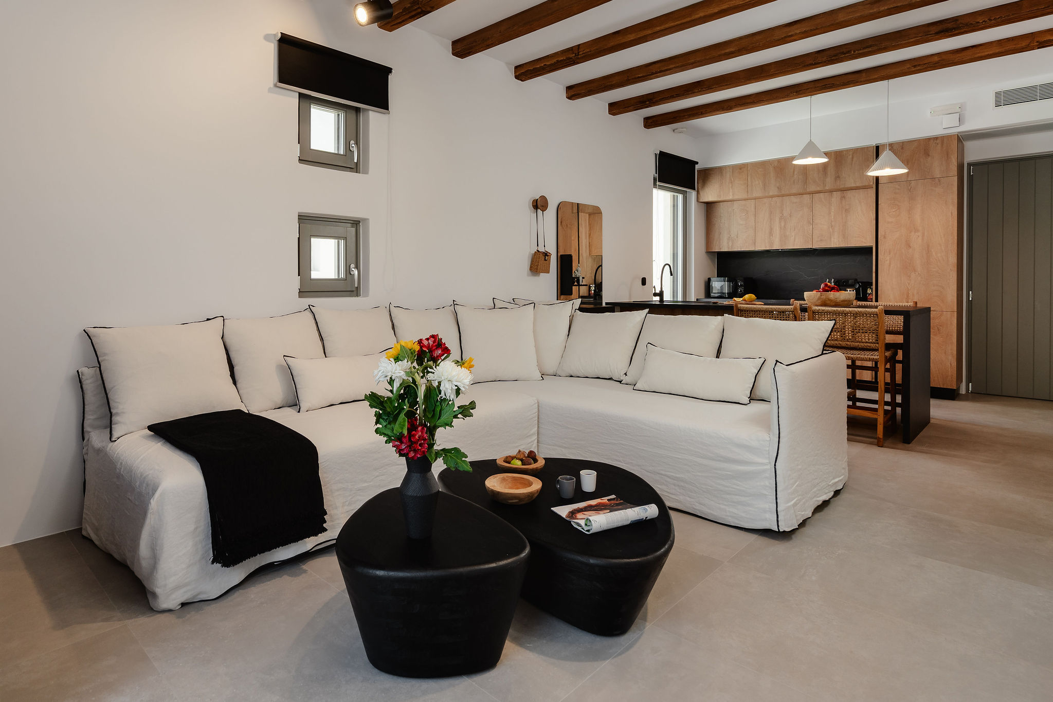 Bright open-plan living room with designer kitchen and cozy sectional