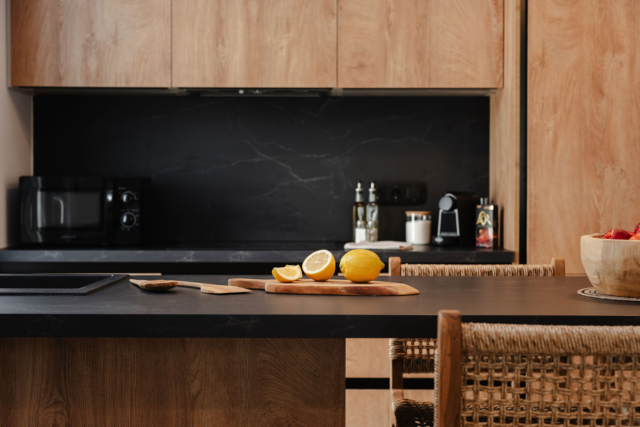 Sleek modern kitchen with warm wood finishes and inviting island seating