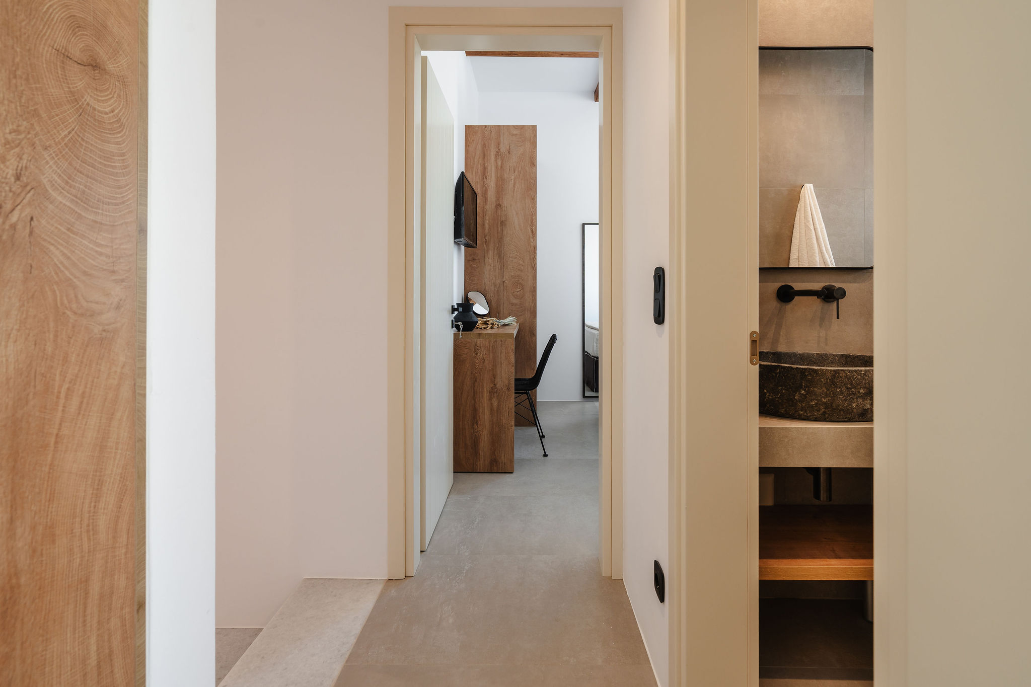 Minimalist hallway with designer vanity and warm wood details