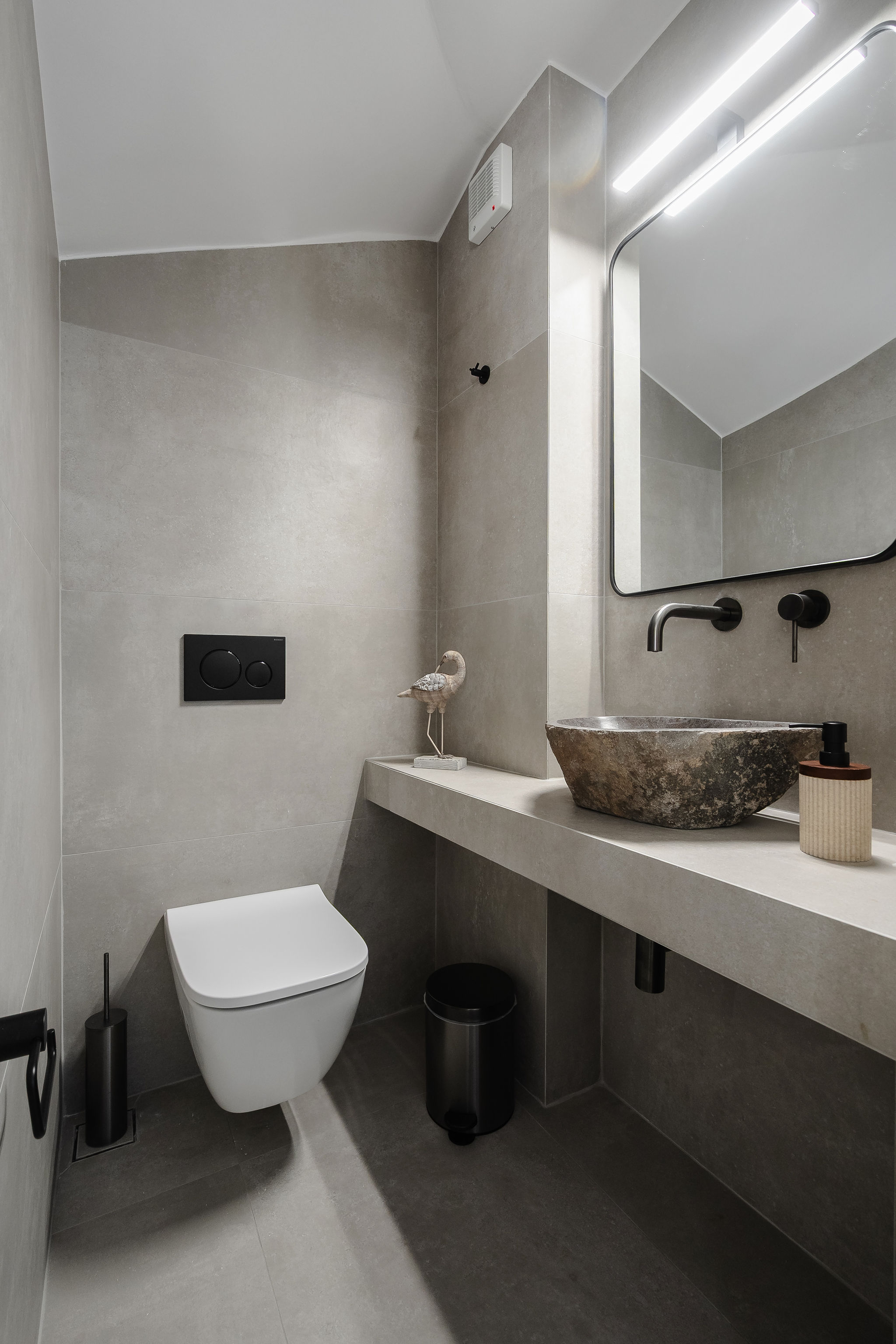 Modern spa-style bathroom with sleek finishes and elegant stone sink