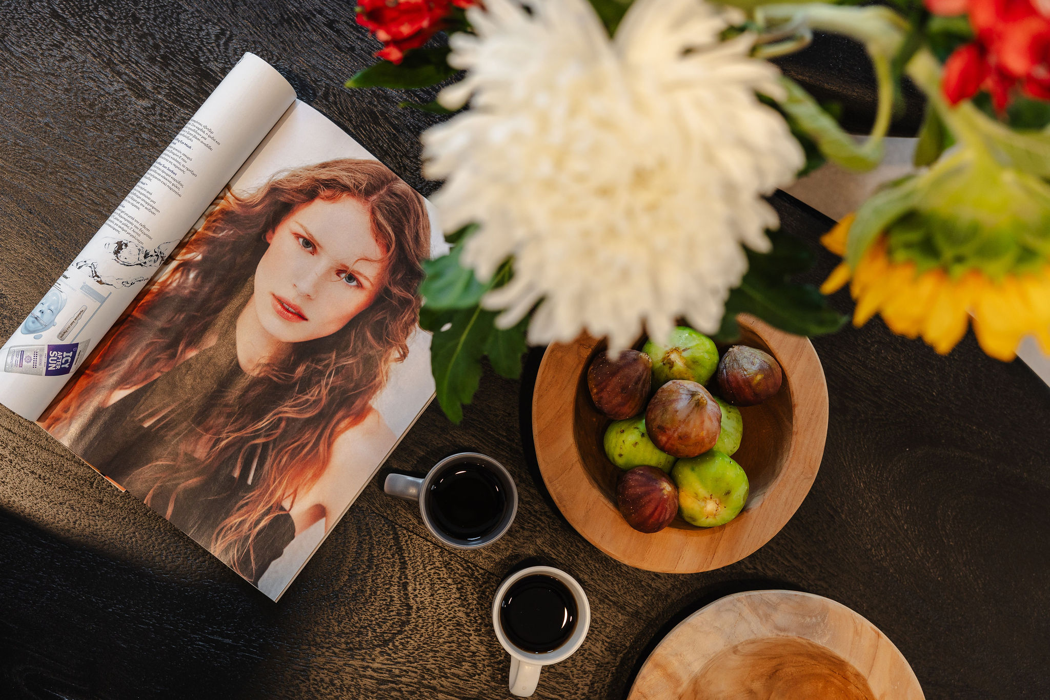 Cozy styled table with coffee, fresh figs, and vibrant floral accents