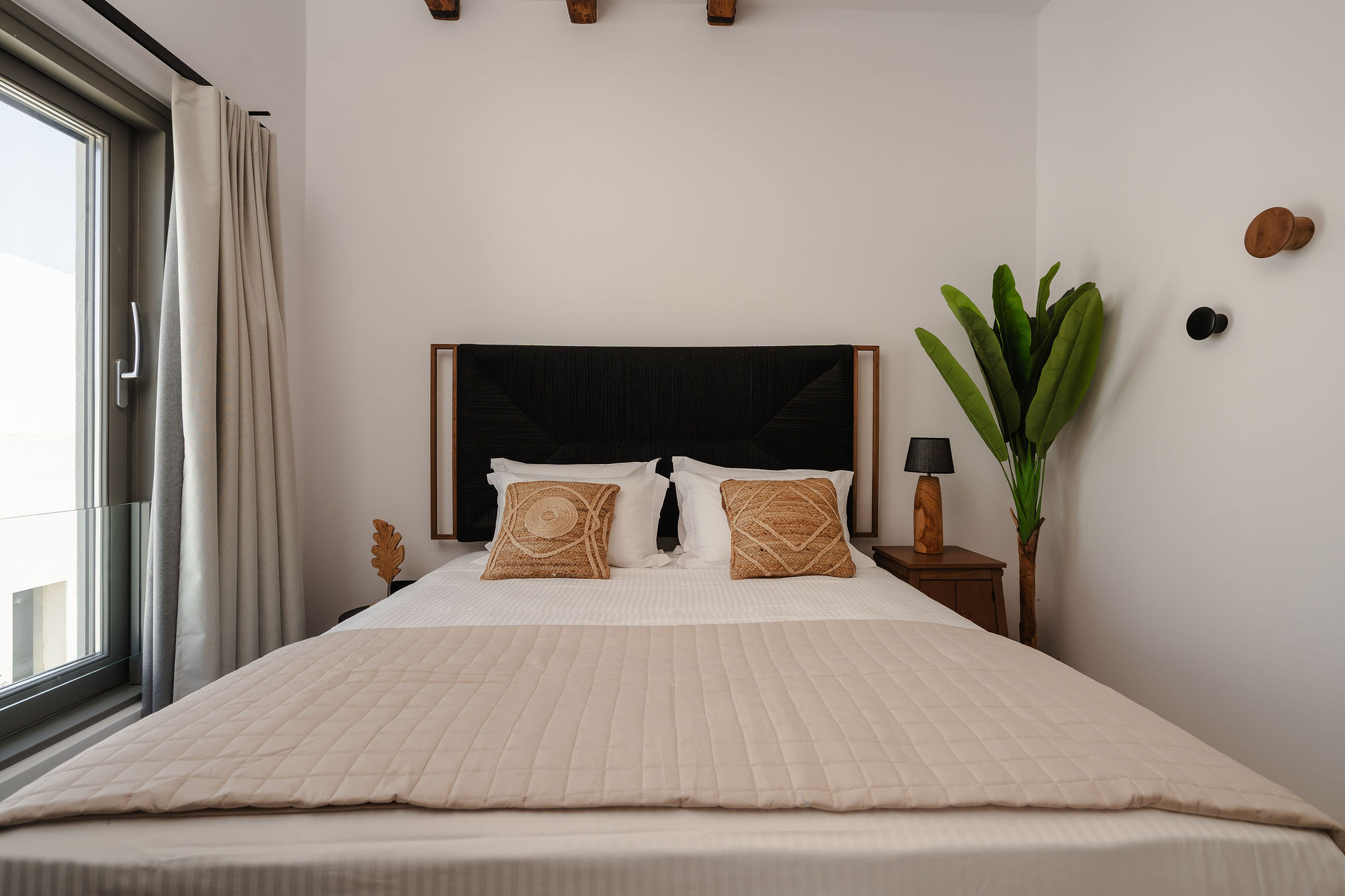 Bright, modern bedroom with elegant styling and natural touches