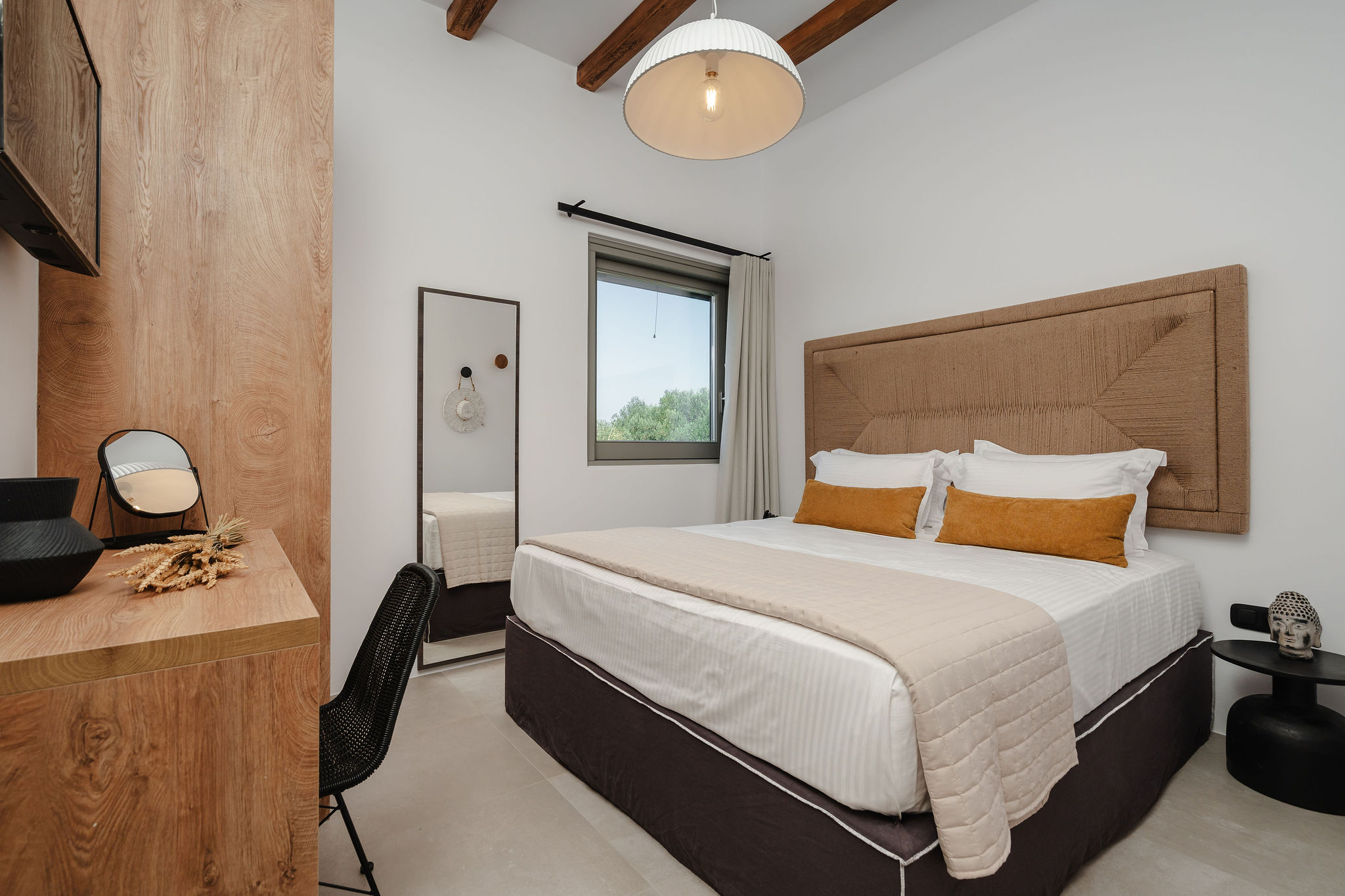Bright designer bedroom with wood accents, workspace, and serene window view