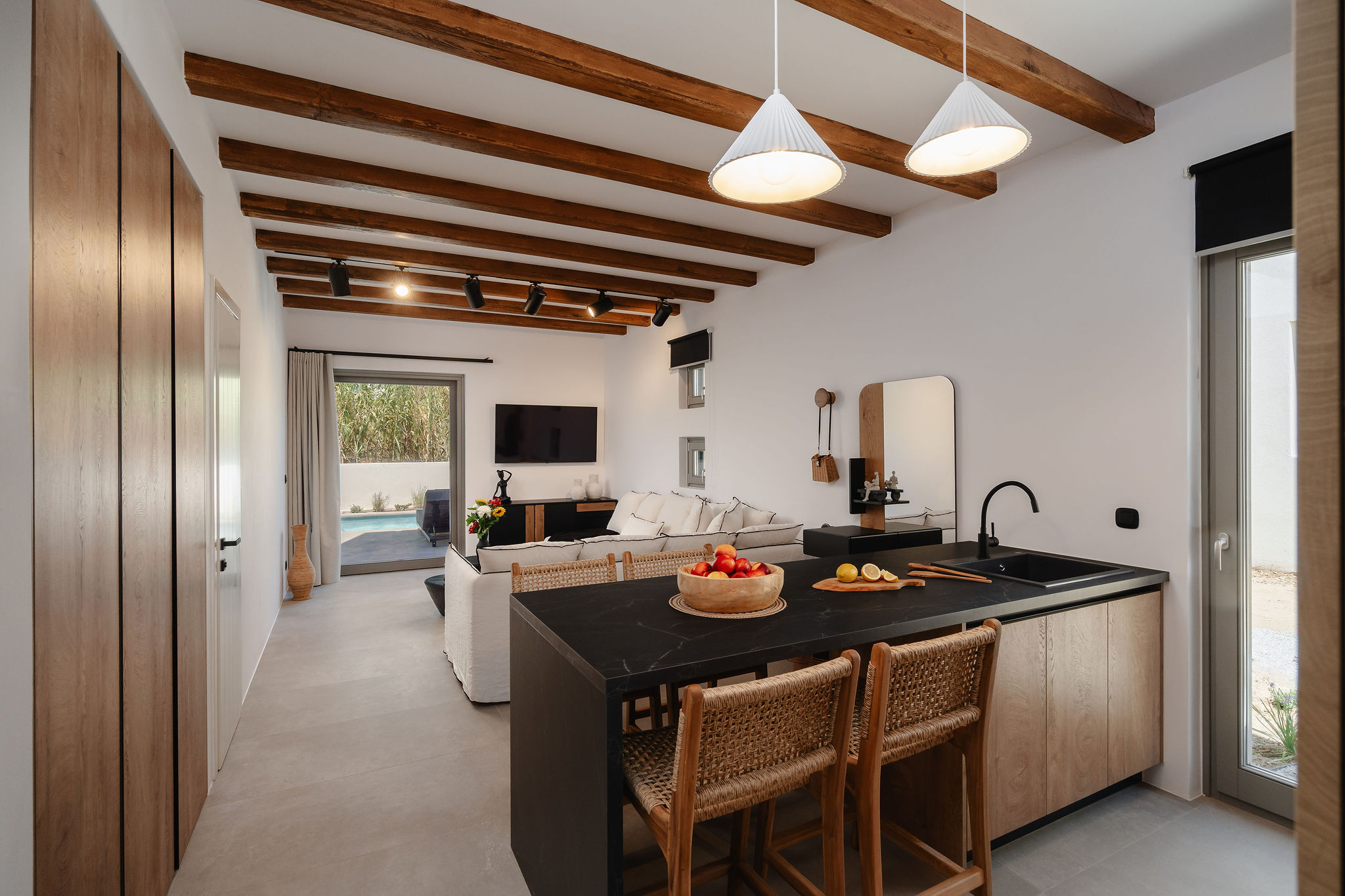 Bright open-plan living with rustic beams and a sleek modern kitchen