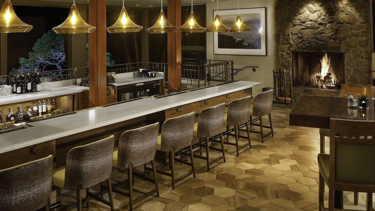 Elegant lounge bar with marble counter and cozy stone fireplace