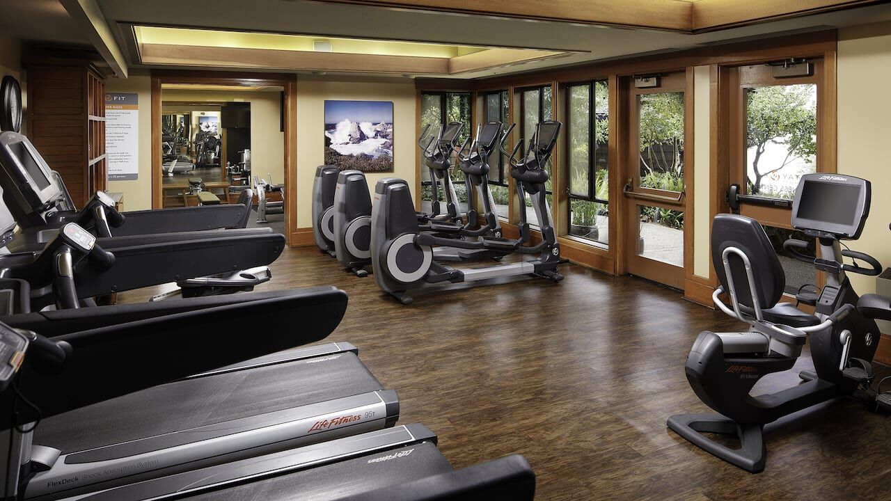Bright, modern fitness room with cardio equipment and natural light