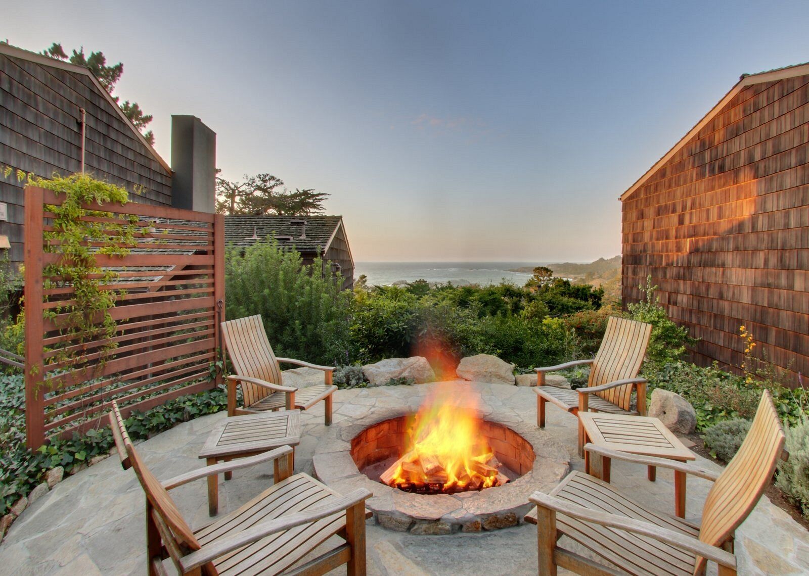 Cozy ocean-view fire pit patio with inviting outdoor seating