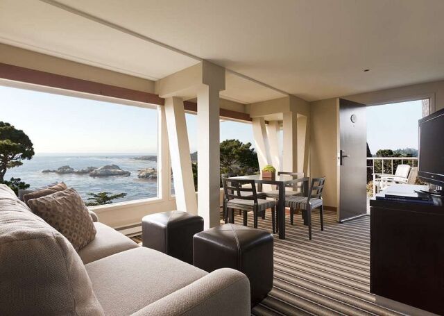 Bright oceanview living room with dining space and private balcony access