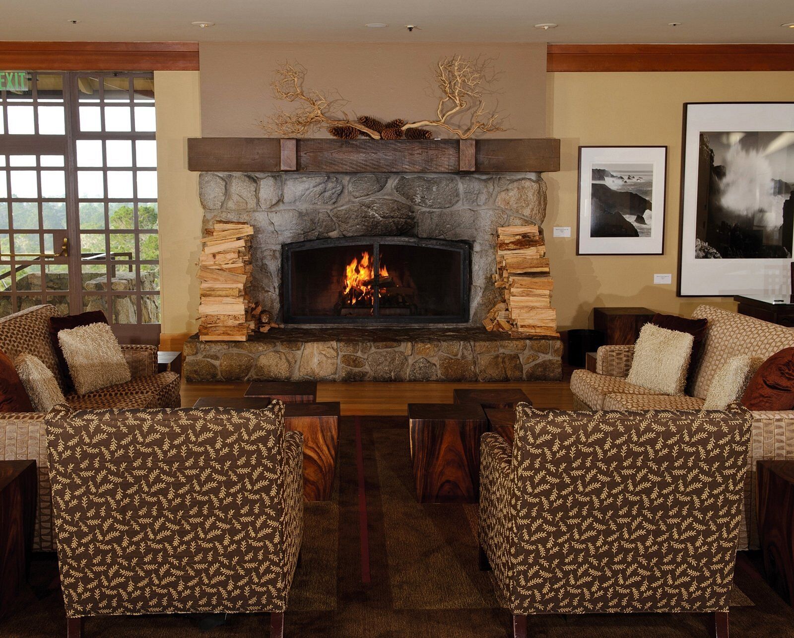 Cozy lounge with stone fireplace and inviting rustic seating
