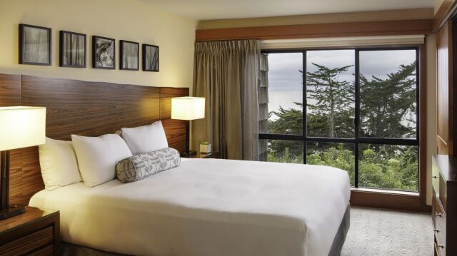 Cozy king bedroom with forest views and warm, modern touches