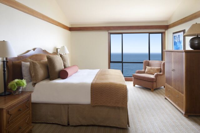 Cozy oceanview bedroom with plush king bed and relaxing sitting area