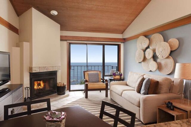 Cozy oceanview living room with fireplace and private balcony