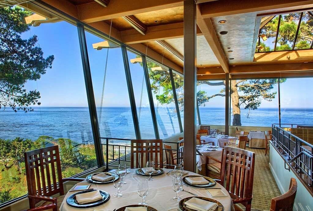 Elegant oceanfront dining with panoramic views and sunlit seating