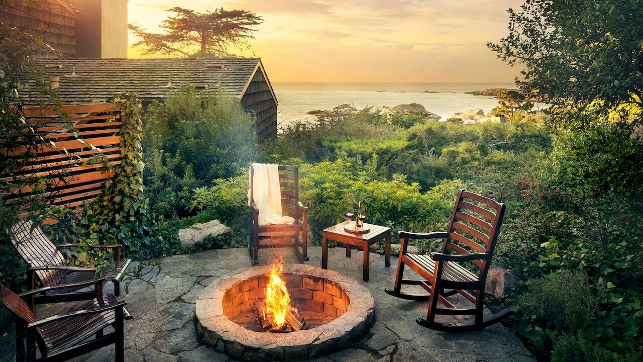 Sunset ocean-view fire pit patio with cozy rocking chairs