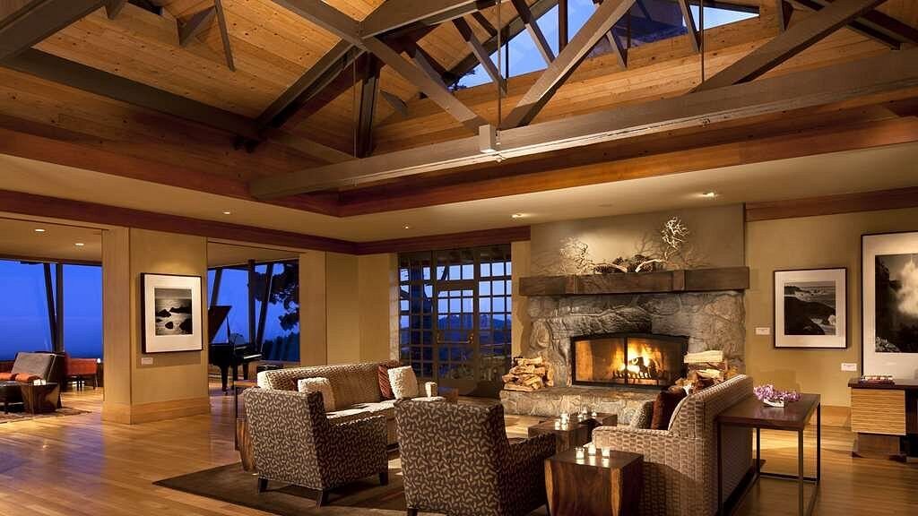 Grand great room with vaulted ceilings, stone fireplace, and scenic views