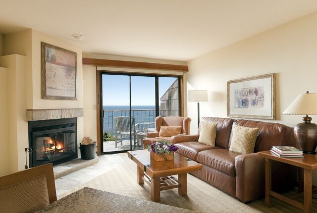 Cozy oceanview living room with fireplace and private balcony seating