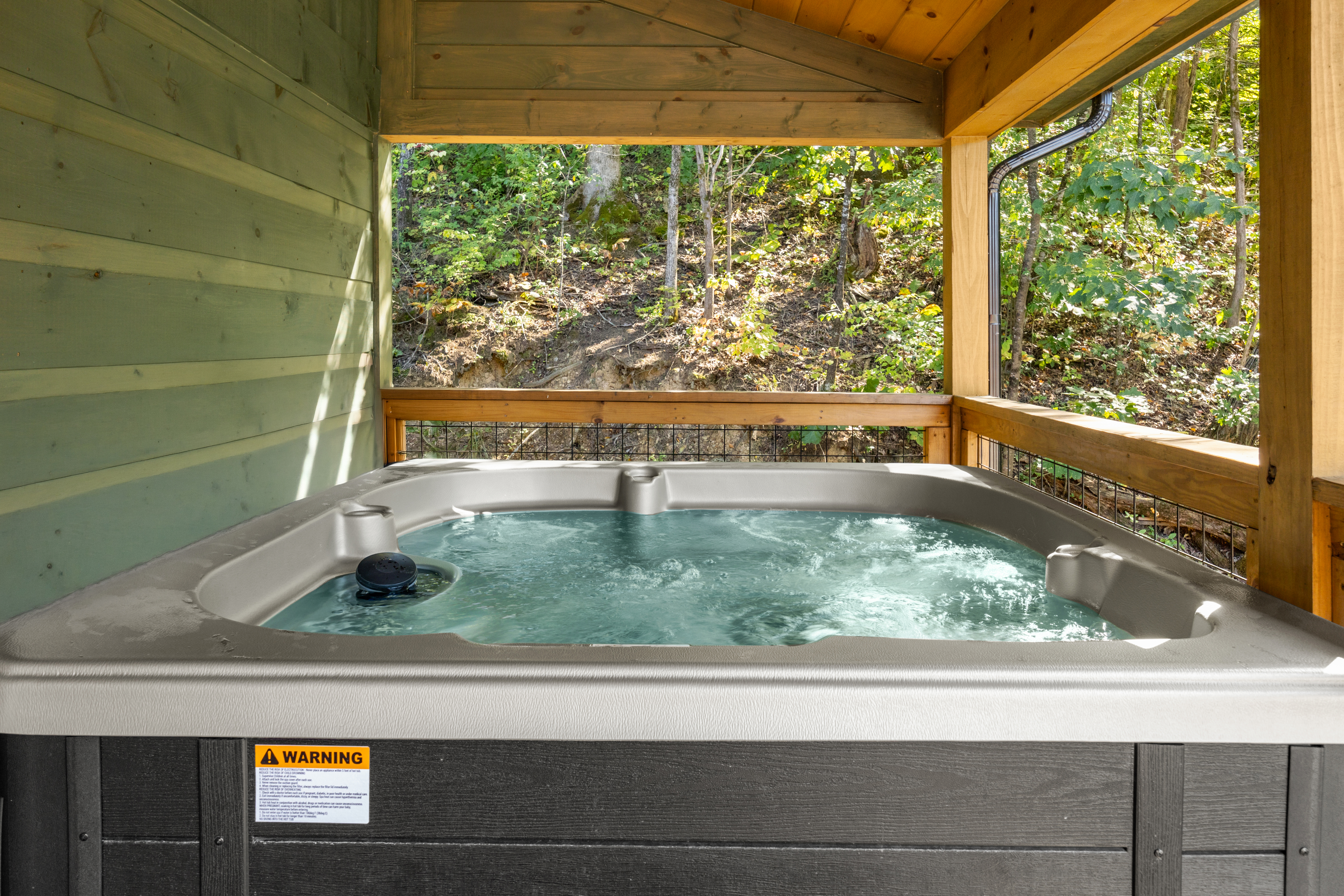 Private covered hot tub with peaceful wooded views