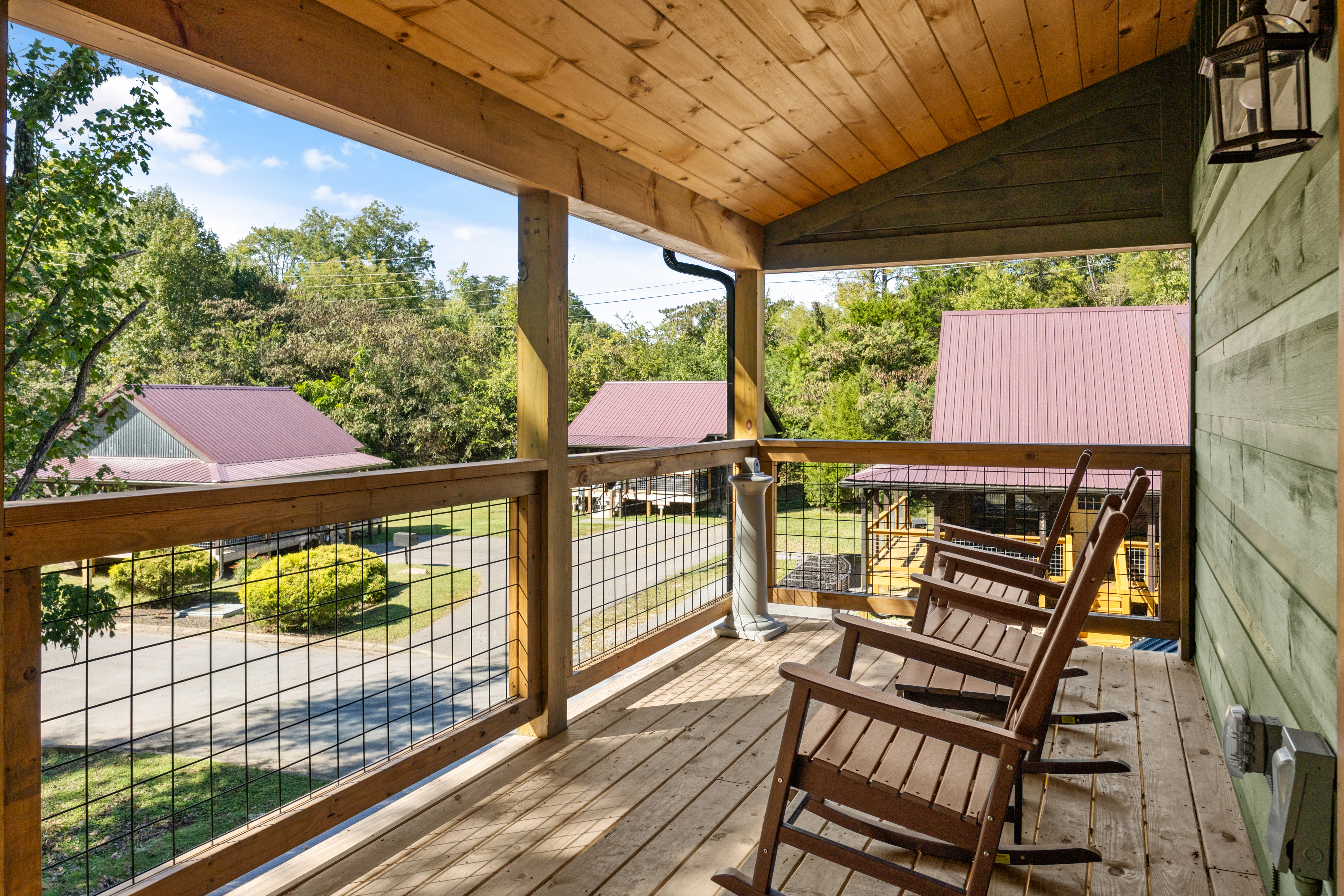 Covered porch with rocking chairs and peaceful cabin views