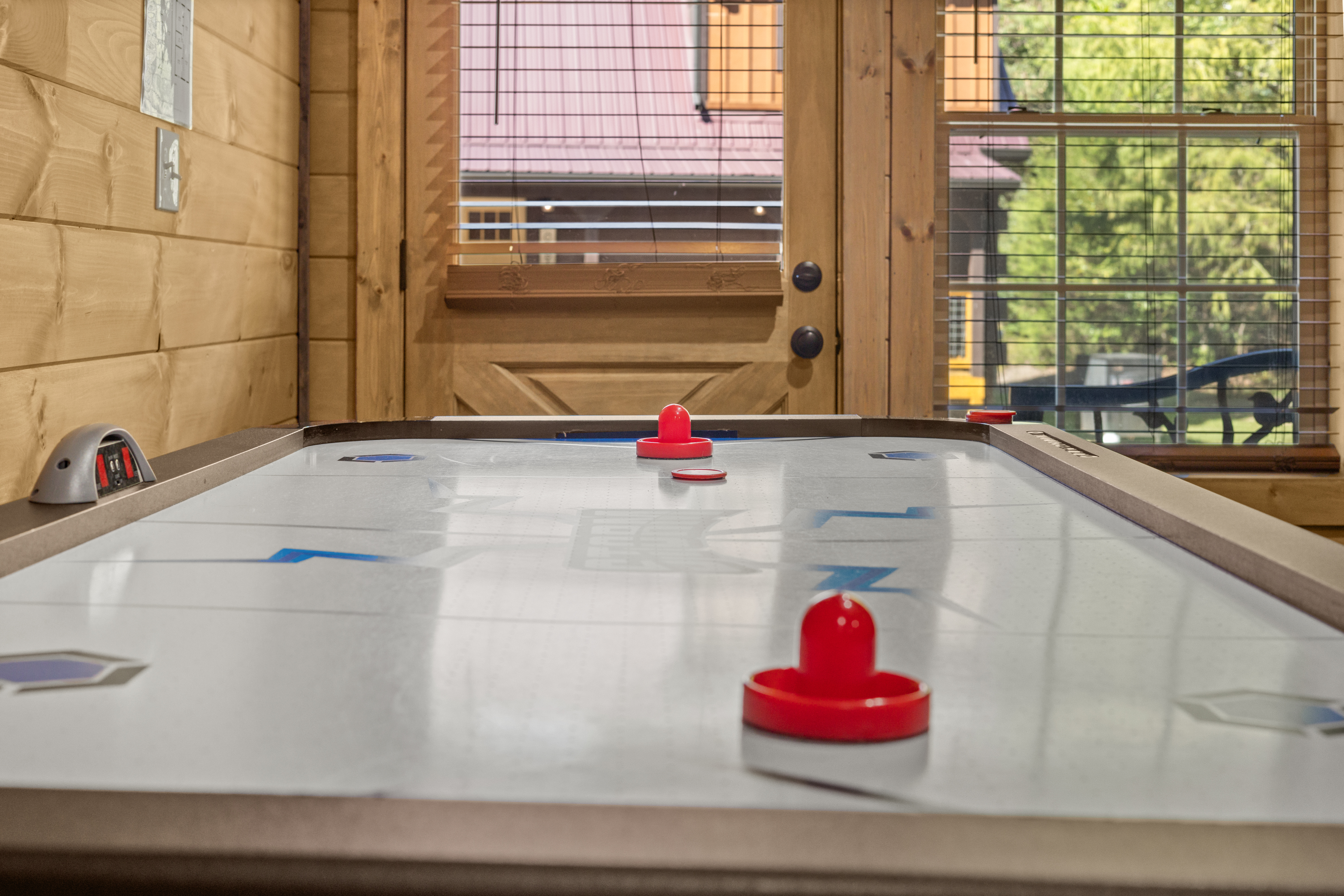 Cozy cabin game room with air hockey and natural light