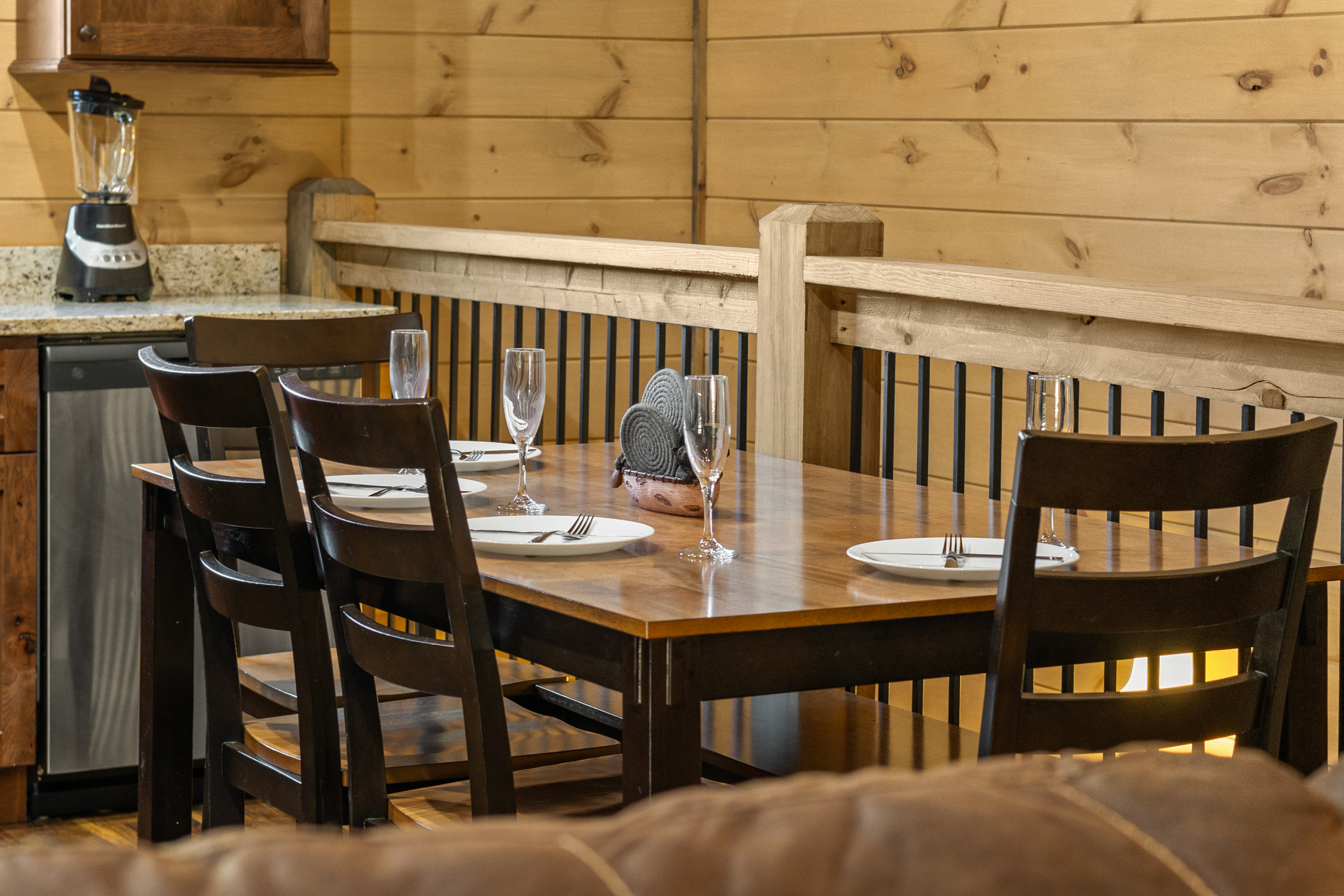 Cozy cabin dining area with seating for four beside the kitchen