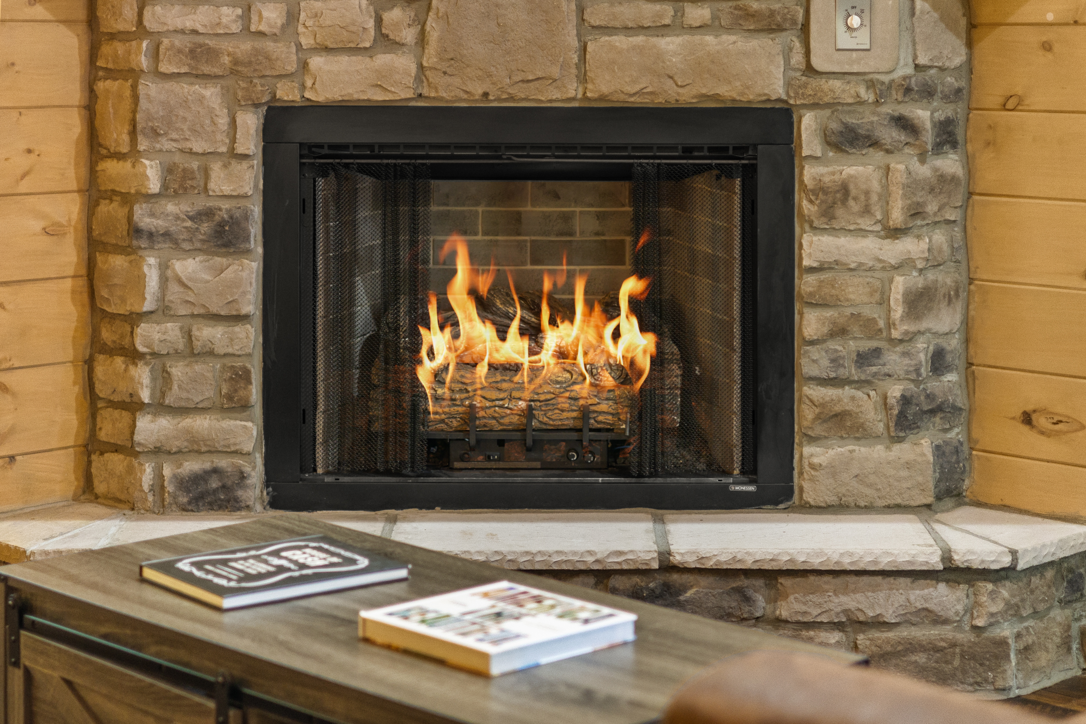 Cozy stone fireplace with warm cabin charm and inviting ambiance