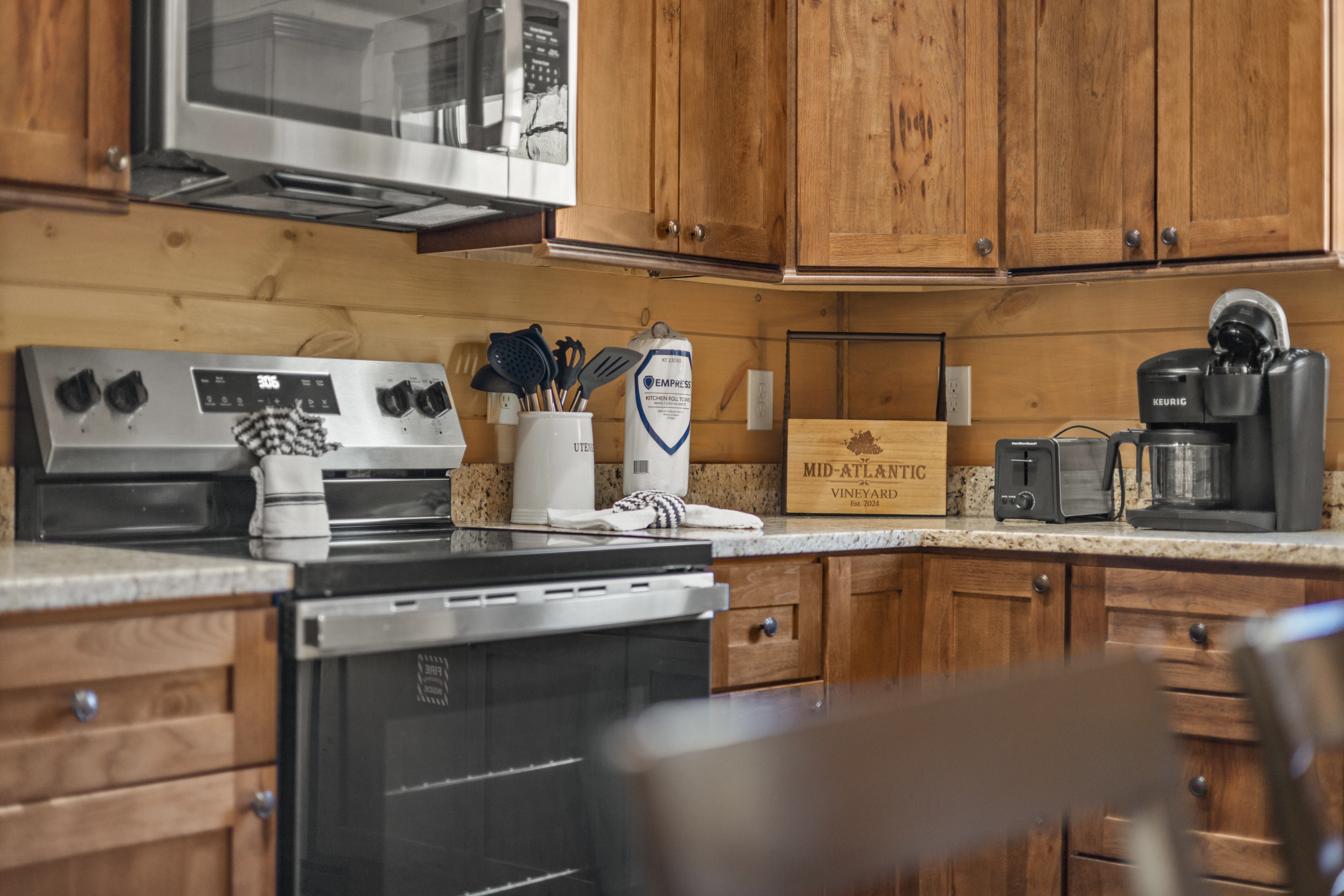 Cozy rustic kitchen with full appliances, coffee maker, and ample counter space