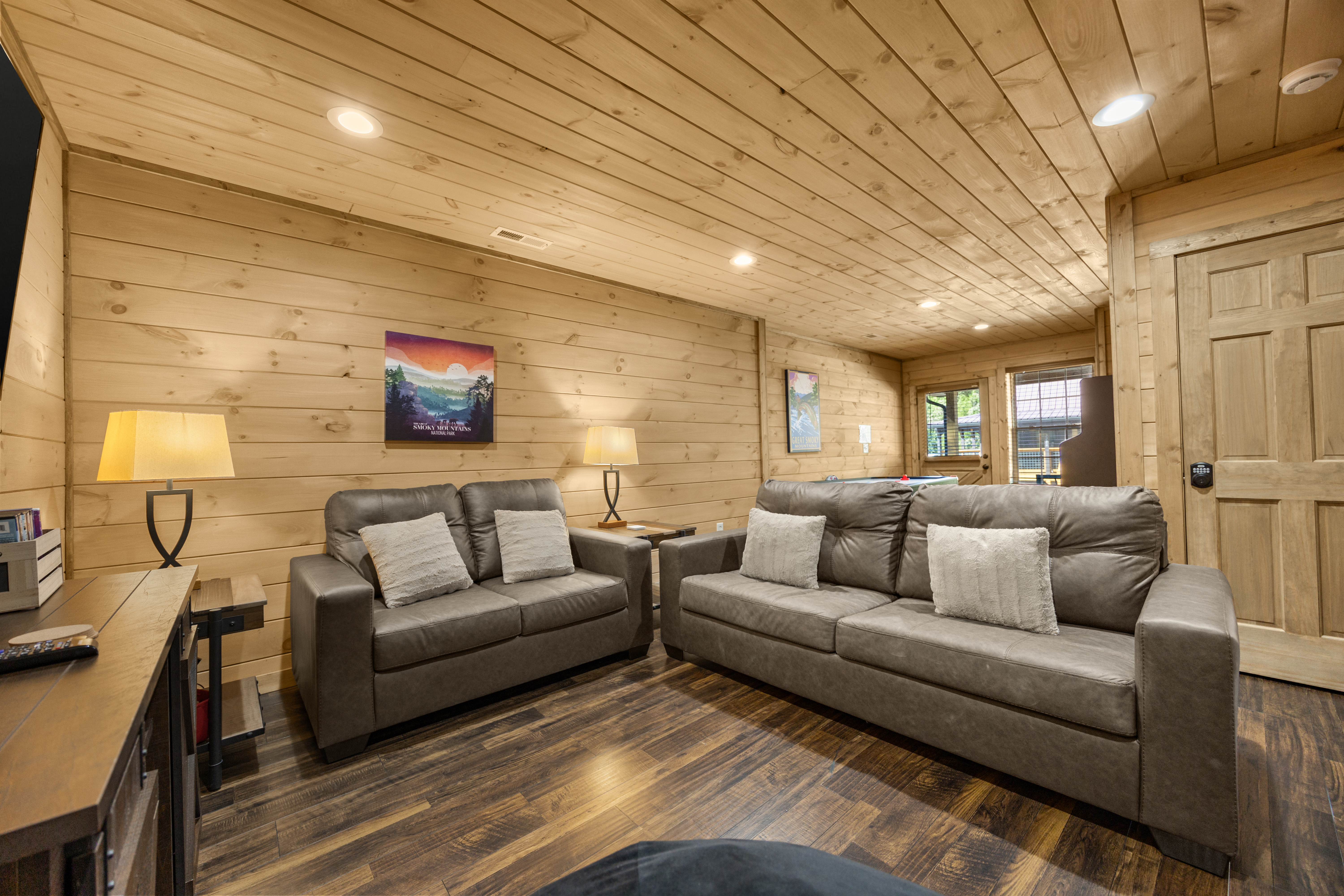 Cozy cabin-style lounge with leather sofas and warm wood interiors
