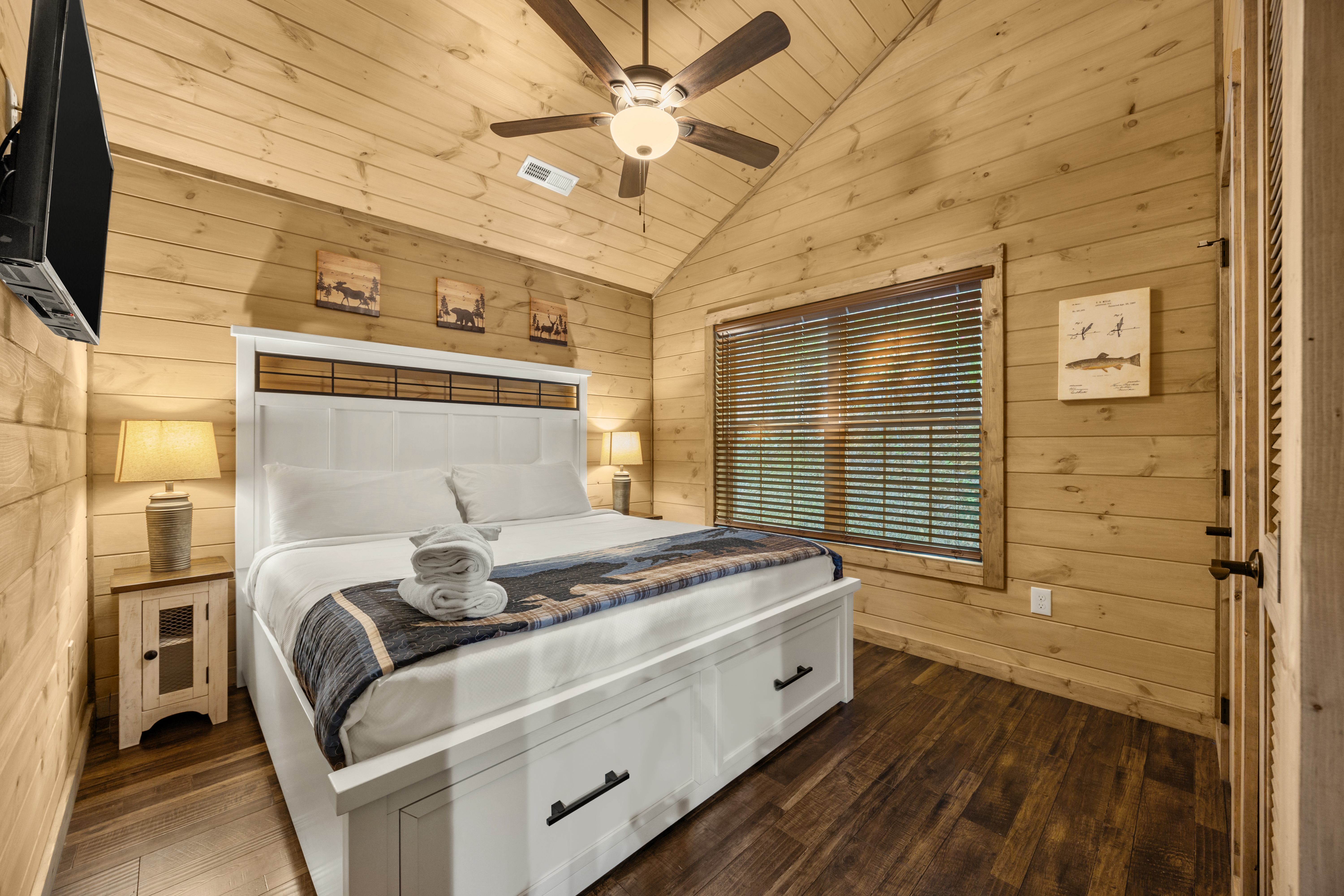 Cozy cabin-style bedroom with vaulted ceilings and a storage bed