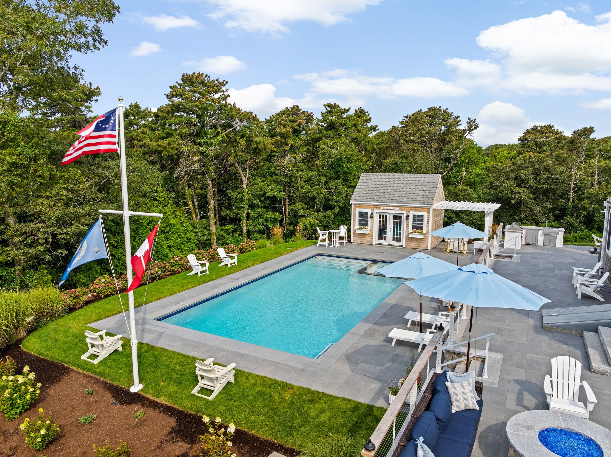 Expansive patio with poolside lounging, dining, and gathering areas.