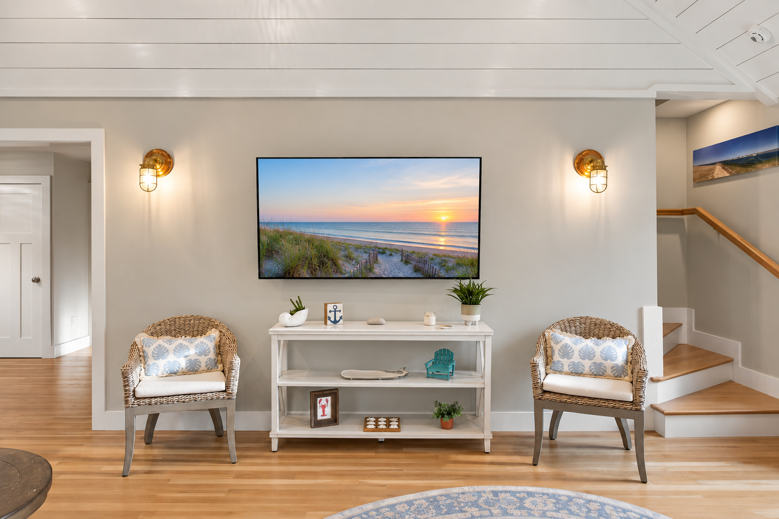 Bright coastal living space with woven chairs, warm lighting, and beachy charm