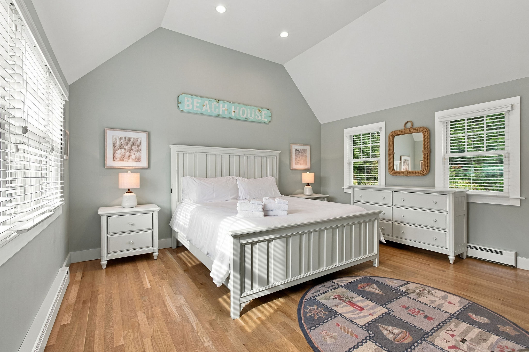 Bright coastal bedroom with vaulted ceilings and airy beach-house charm