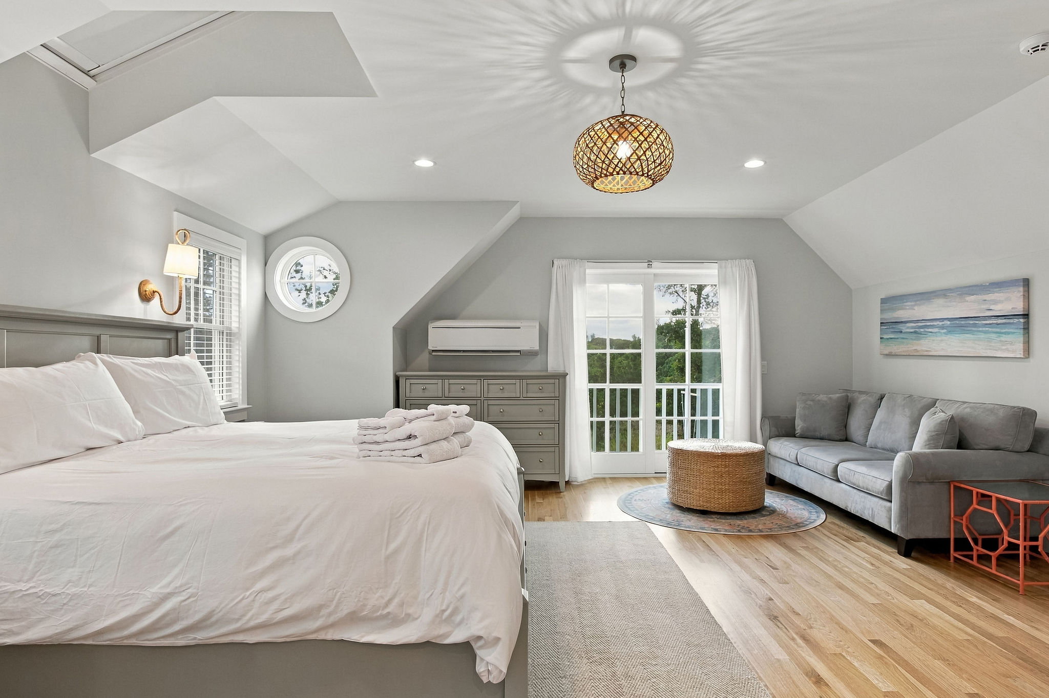 Bright king suite with cozy lounge area and private balcony access