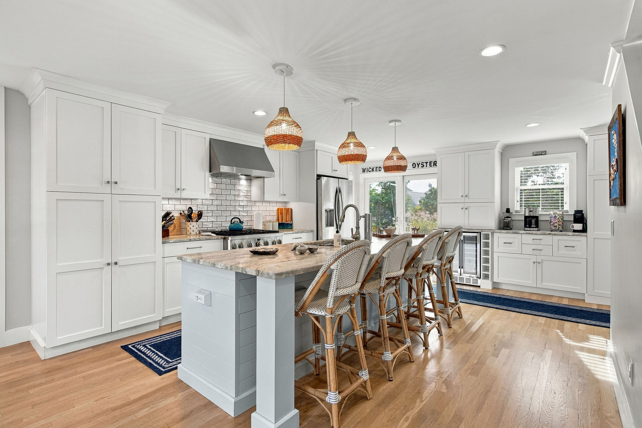 Bright designer kitchen with large island seating and beverage station
