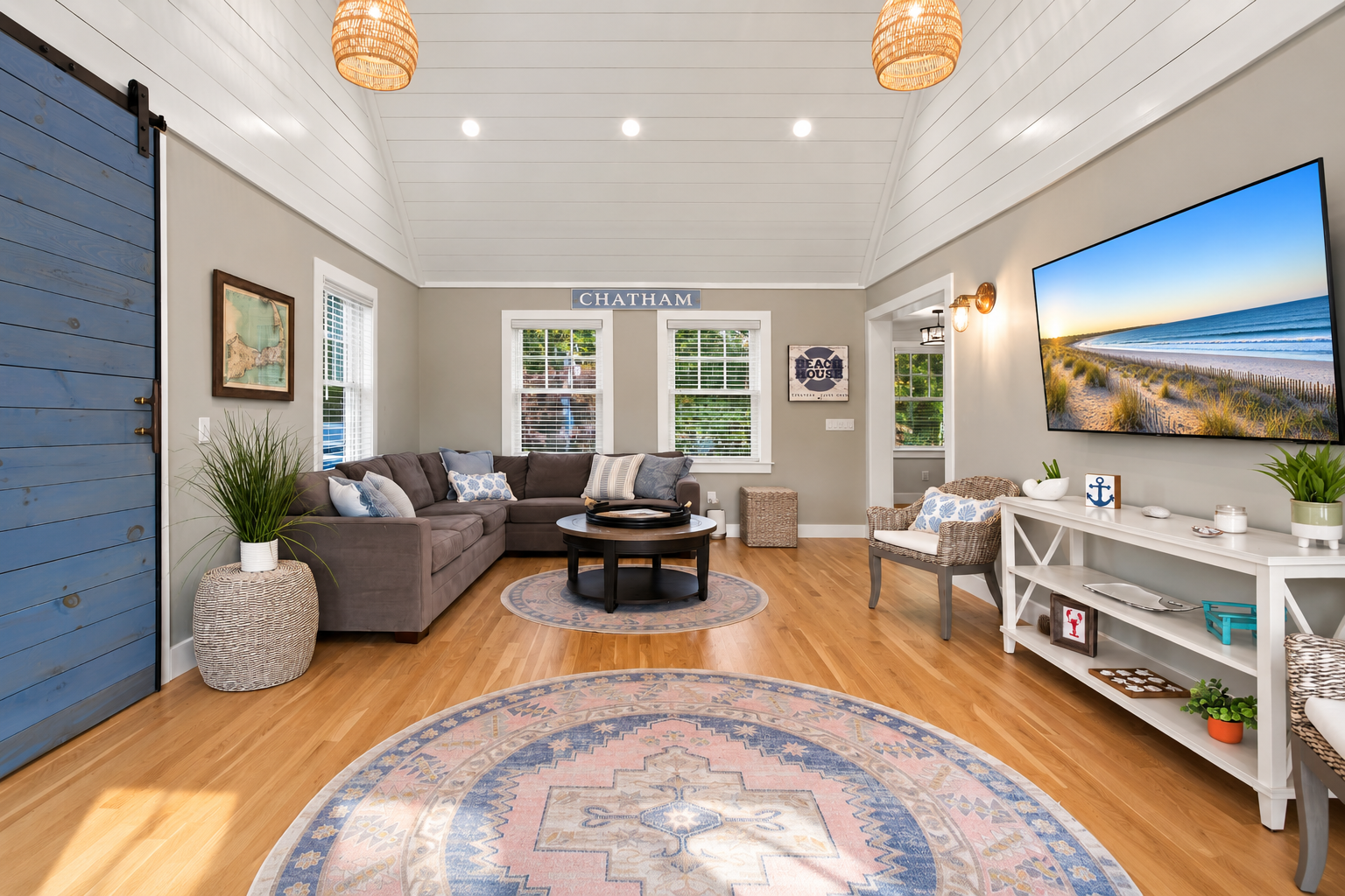 Bright coastal living room with vaulted ceilings and cozy seating