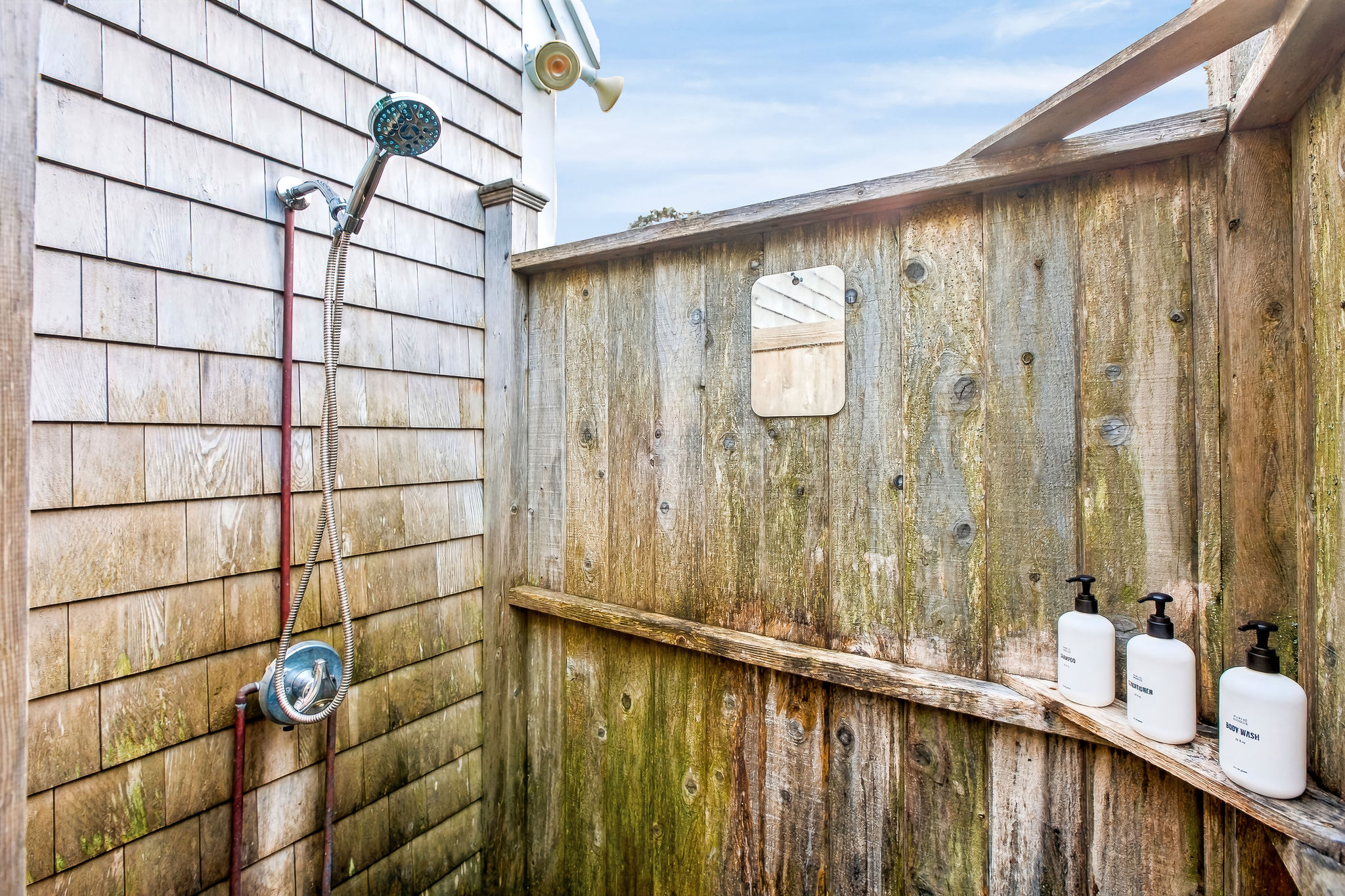 Private outdoor shower with rustic coastal charm